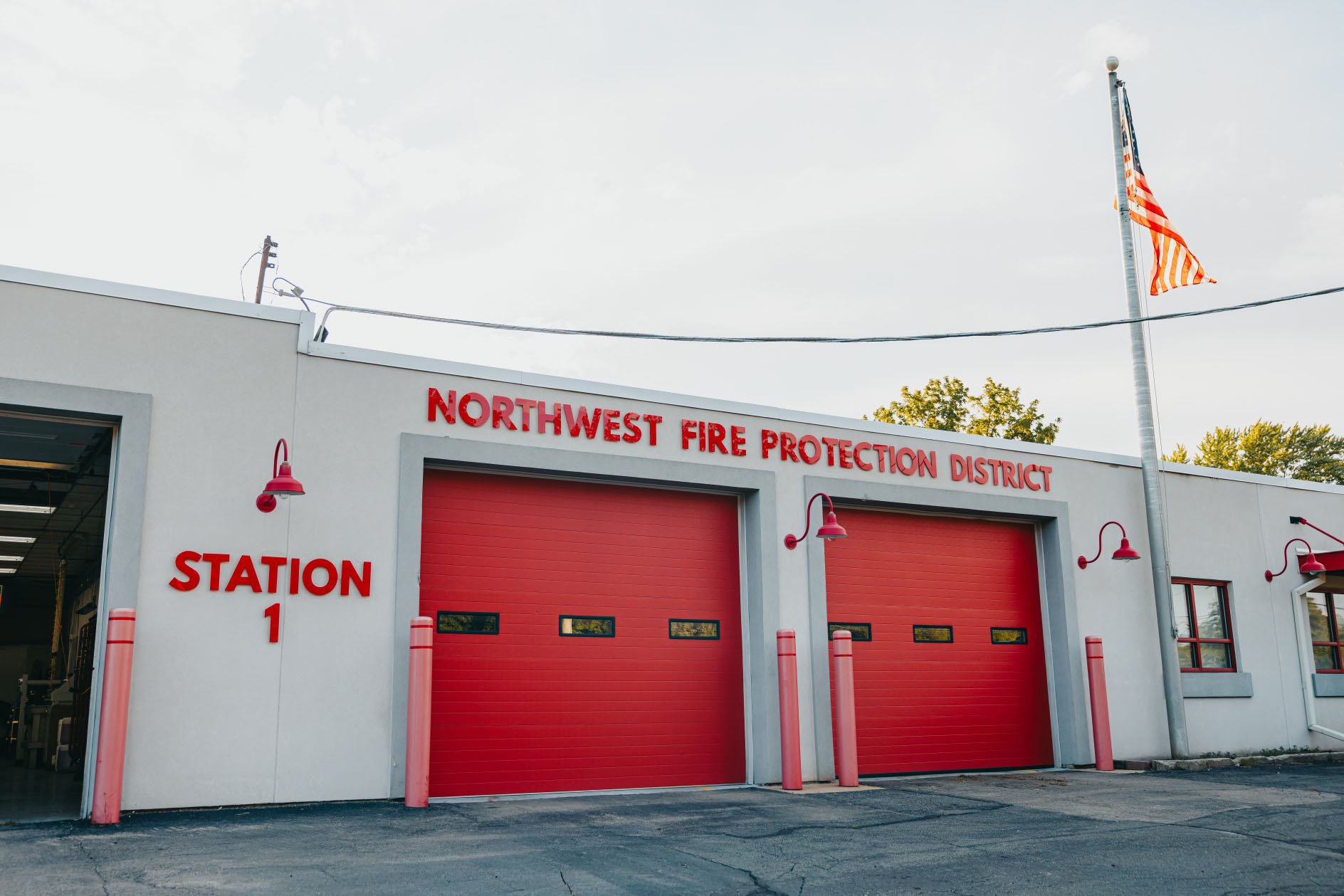 Northwest Rescue Rockford Westside station with red apparatus bay doors and Station 1 signage
