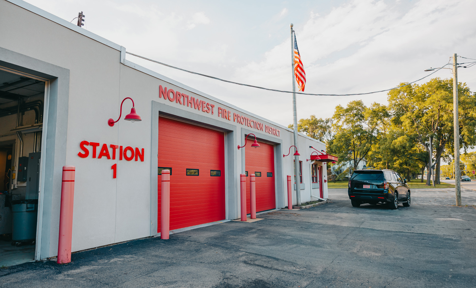 Angled view of the Northwest Rescue Rockford Westside station bays and flagpole from the lot