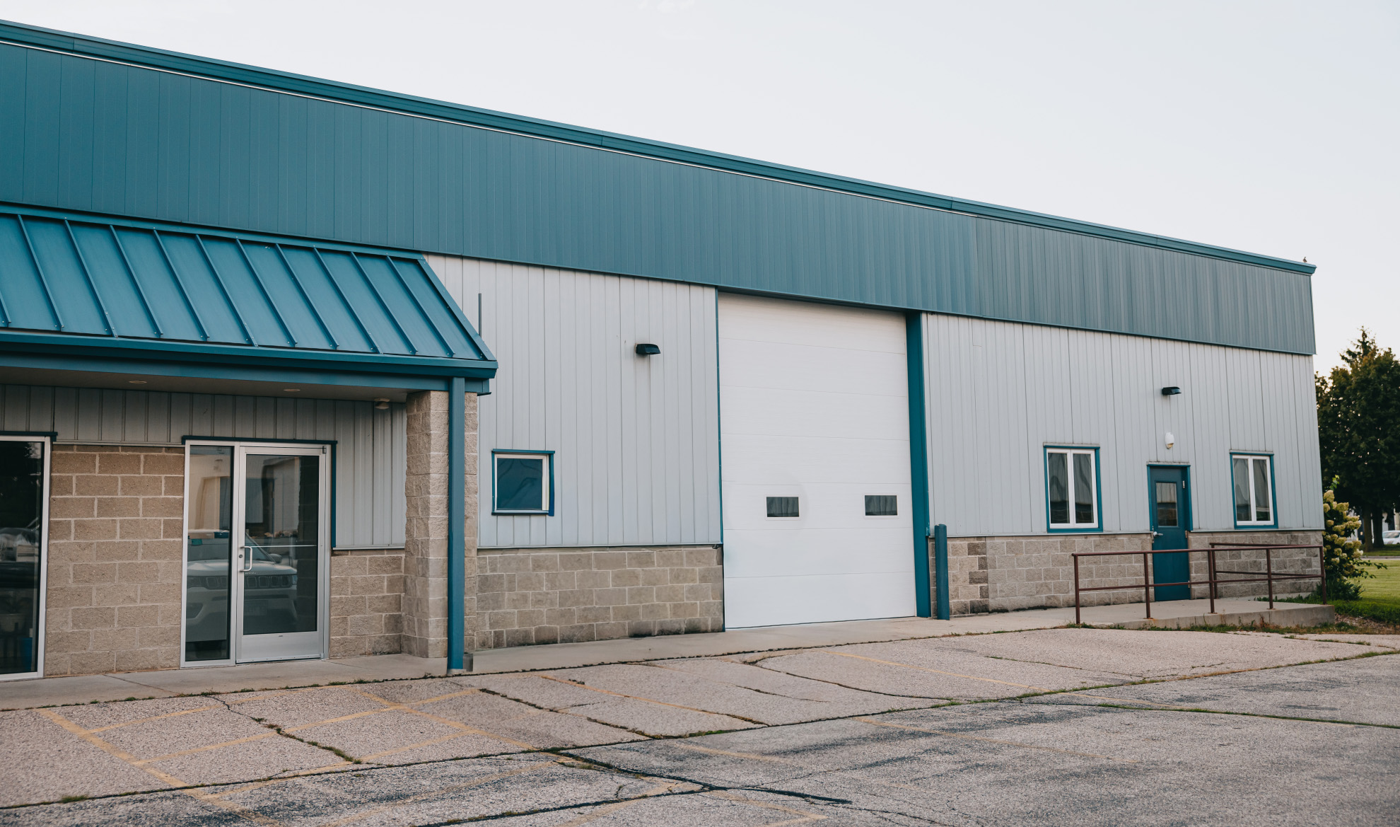 Northwest Rescue Delavan station exterior with teal trim and apparatus bay entrance