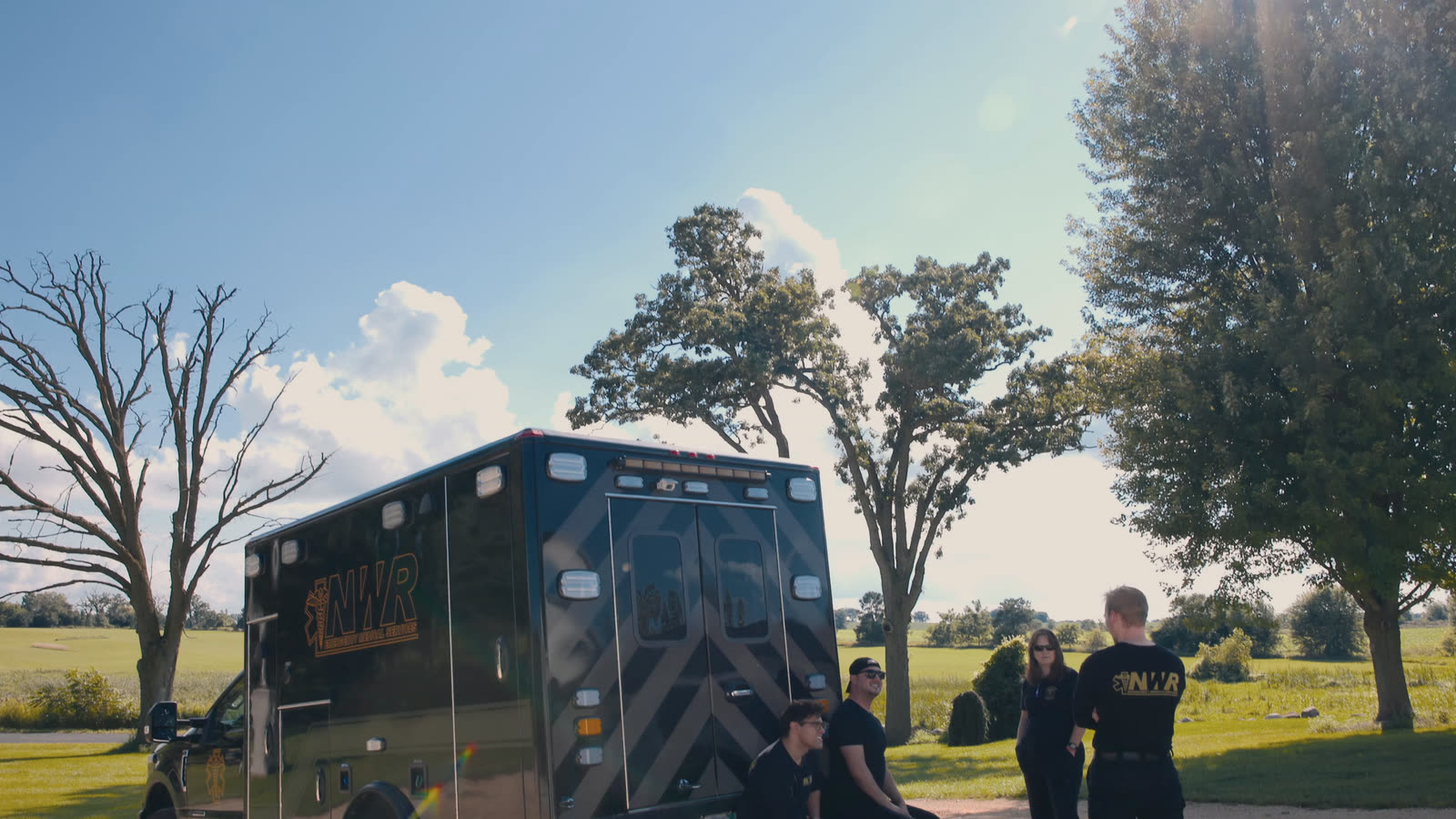 Northwest Rescue crew members standing beside an ambulance