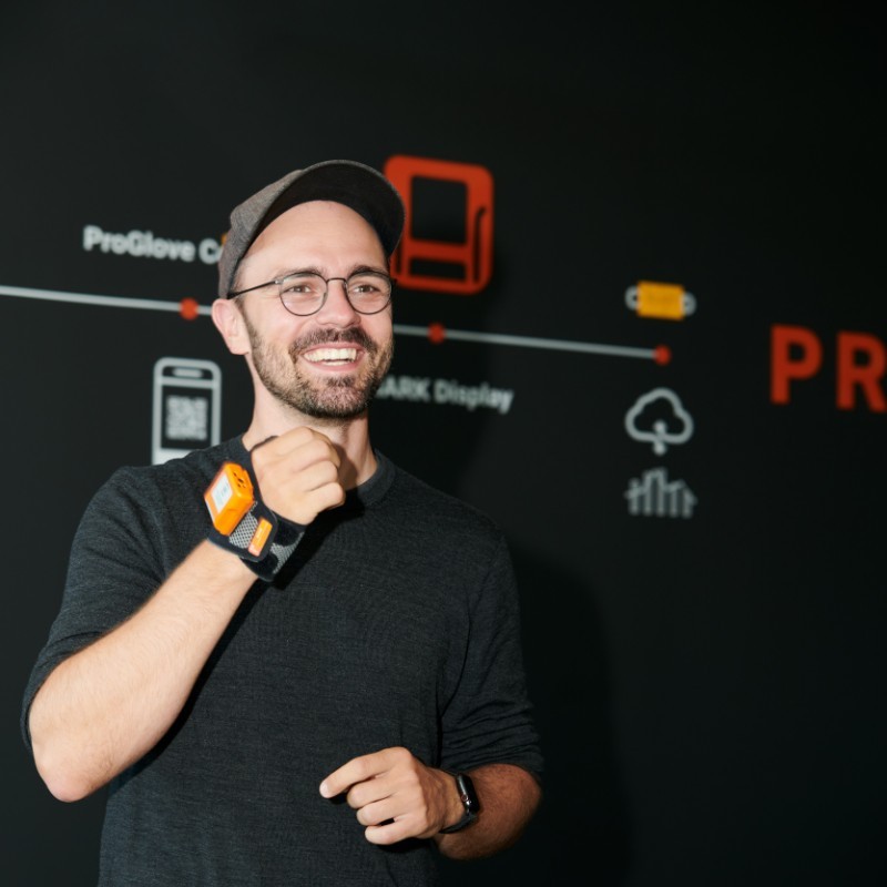 Thomas Kirchner, Co-Founder of ProGlove, demonstrating their industrial wearables to connect human workers with industrial IoT.