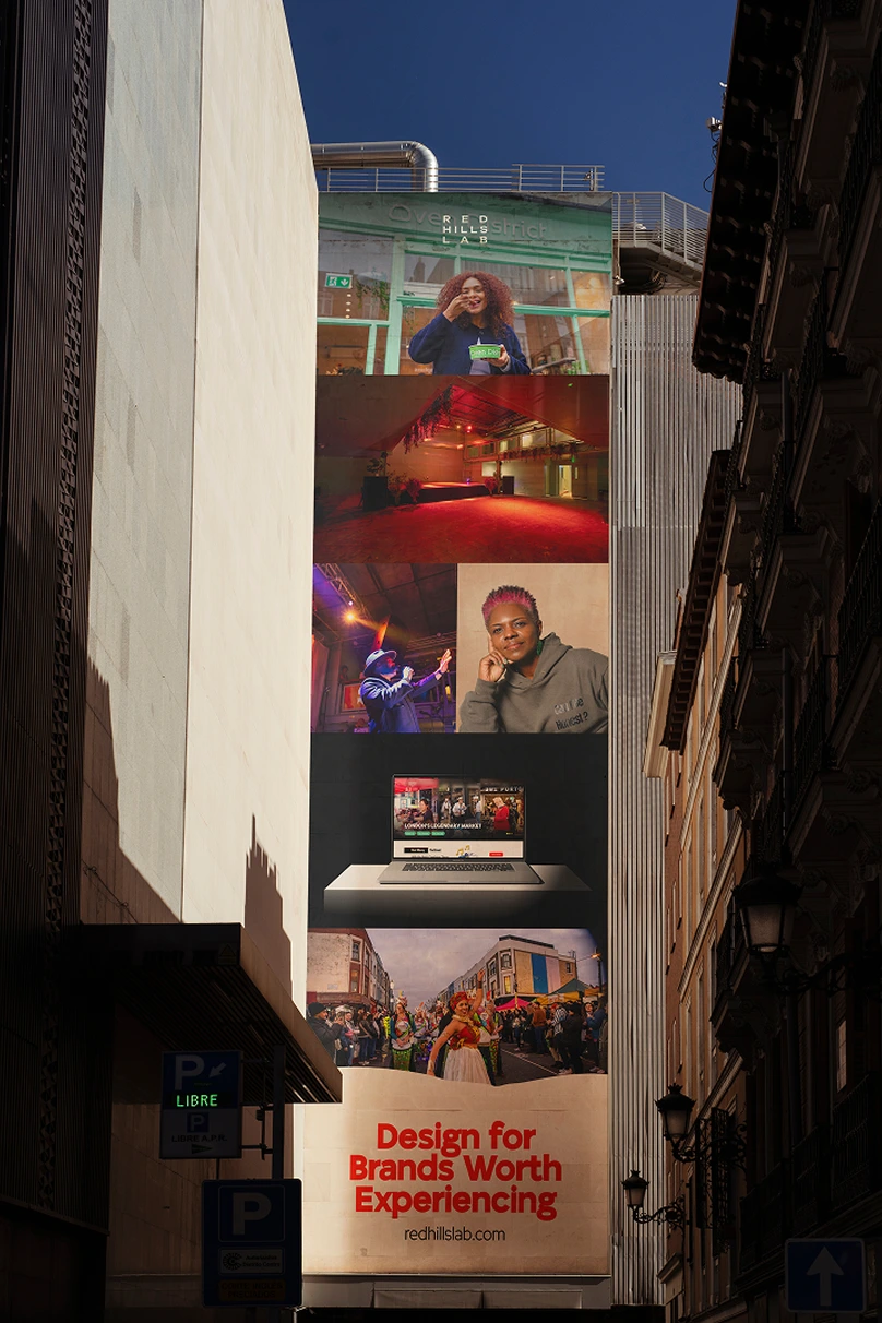 Vertical building banner with photos and text: Design for Brands Worth Experiencing, redhillslab.com.