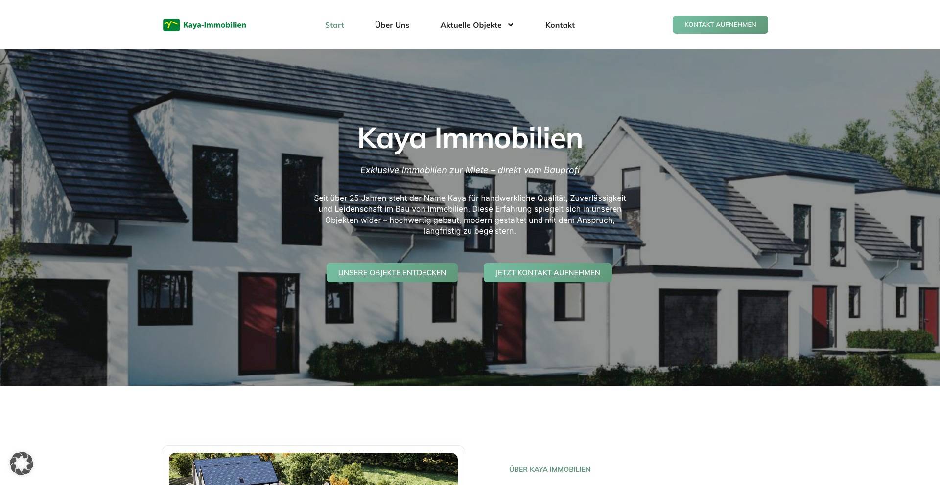 Modern row of white houses with dark roofs and red doors in a residential neighborhood under a clear sky.