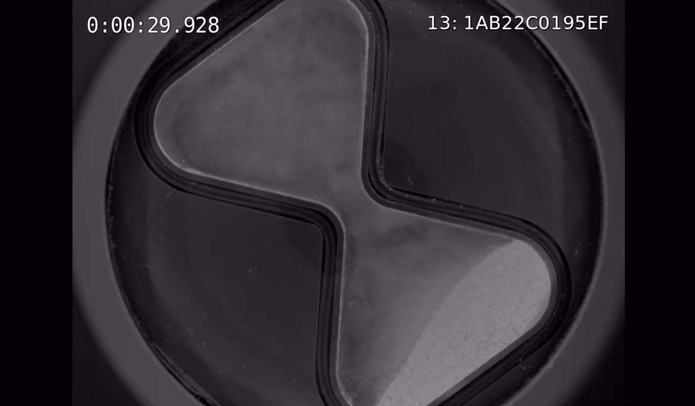 Close-up of layered 3D-printed concrete paths forming curved cells with timestamp overlay