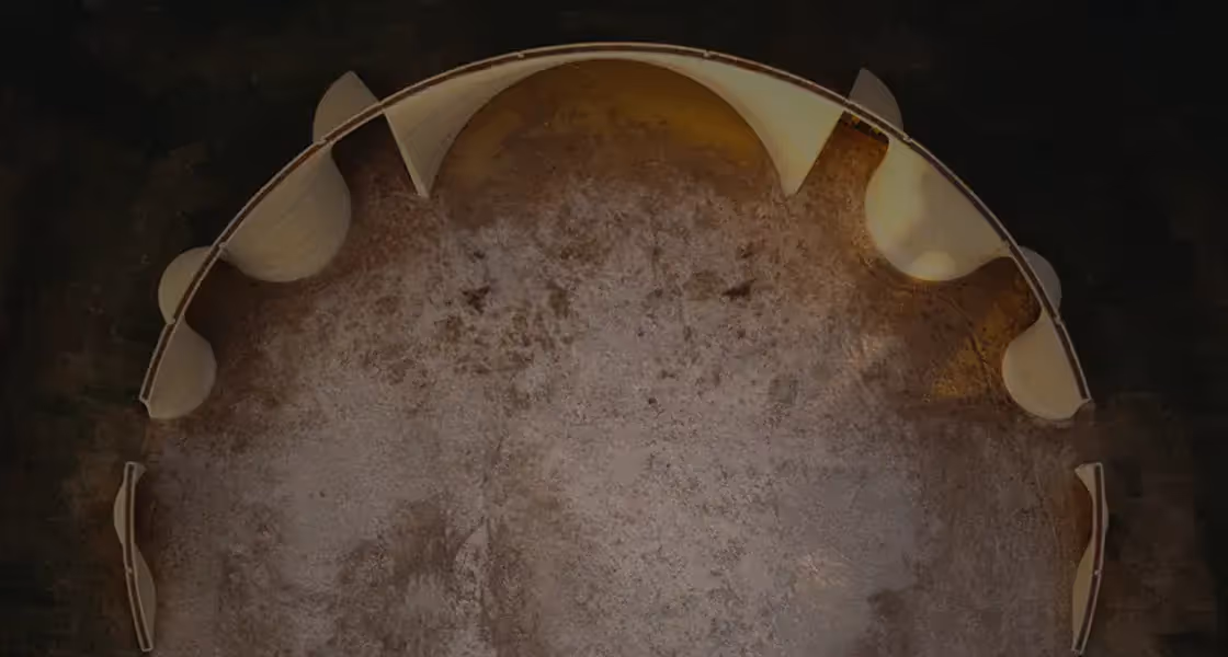 Aerial view of a half-built circular 3D-printed structure with curved interior walls