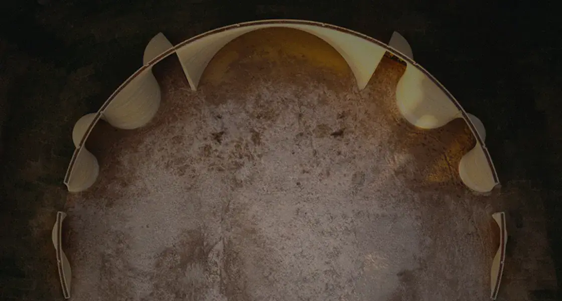 Aerial view of a half-built circular 3D-printed structure with curved interior walls