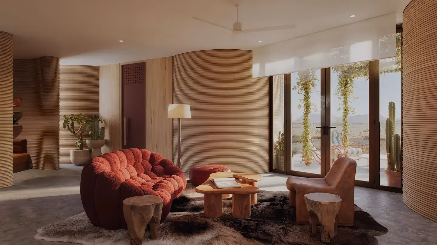 Living room with red sofa, wooden coffee tables, leather chair, ribbed curved walls and glass doors