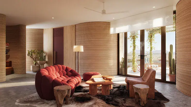 Living room with red tufted sofa, wooden stools, fur rug, and glass doors opening to a patio