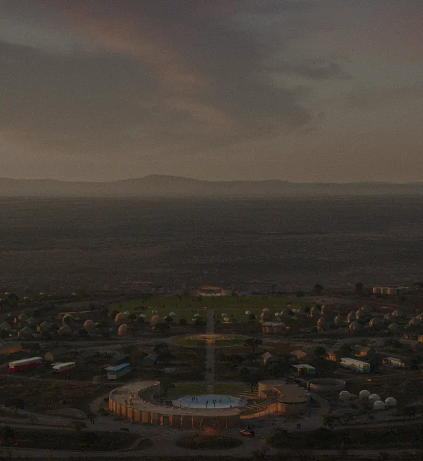 Aerial view of circular plaza and cluster of dome buildings under a dusky sky