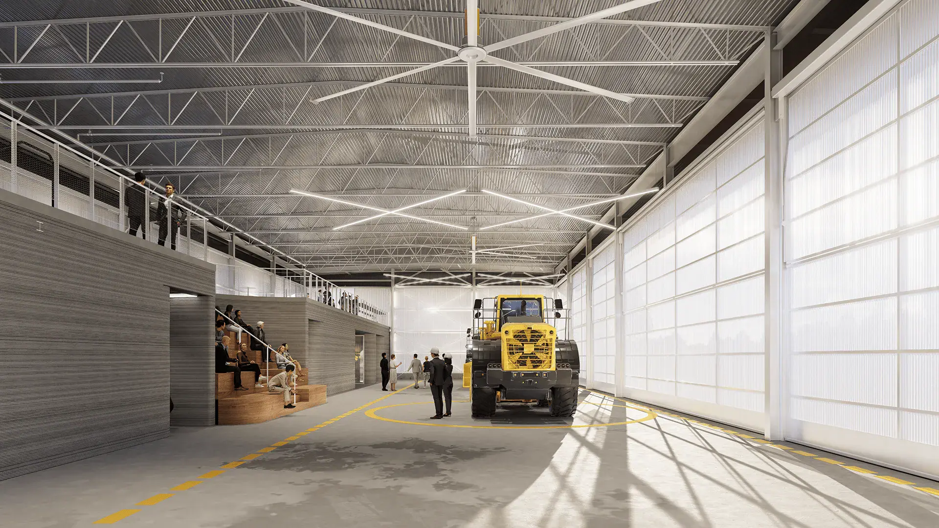 Interior industrial workshop with yellow loader, people, and tiered seating