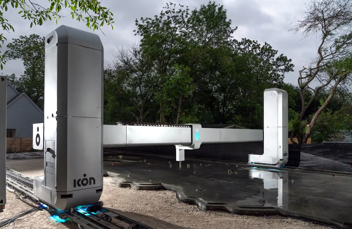 ICON gantry 3D-printing robot laying concrete slab for a home foundation, showcasing robotic construction technology