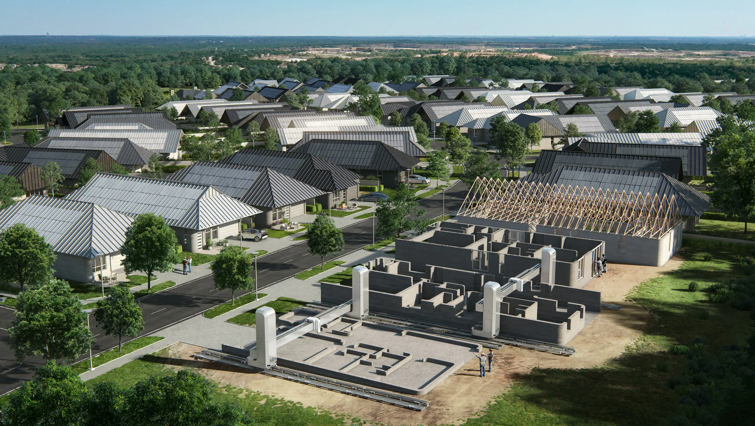Aerial view of robotic gantry 3D-printing concrete home shells next to completed solar-roof houses