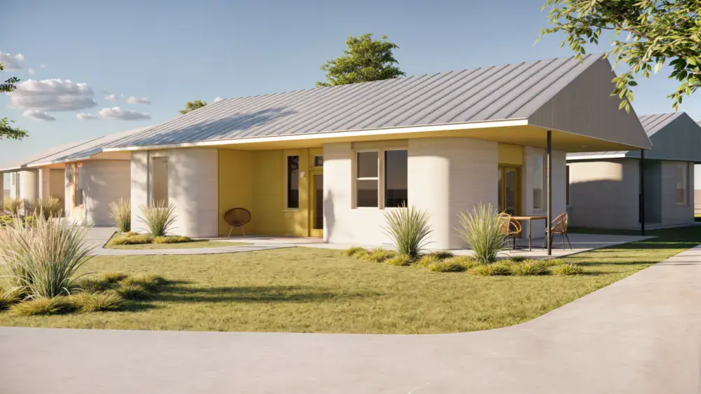 Single-story modern 3D-printed home with curved walls, metal roof and front porch in landscaped residential community