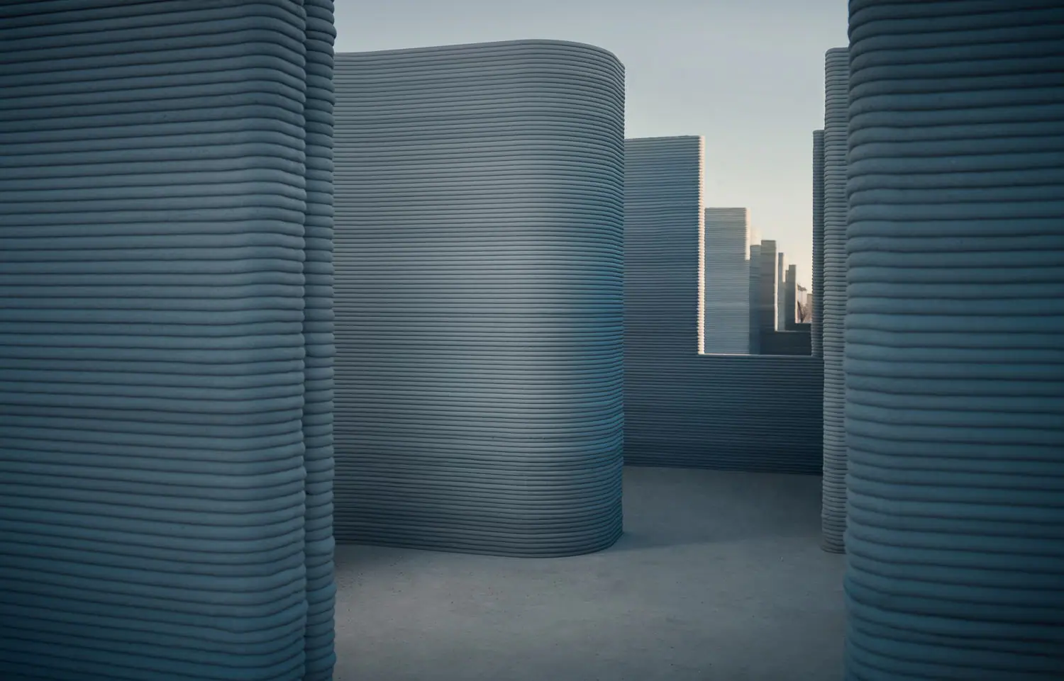 Curved layered 3D-printed concrete walls forming corridors, illustrating robotic additive construction for housing