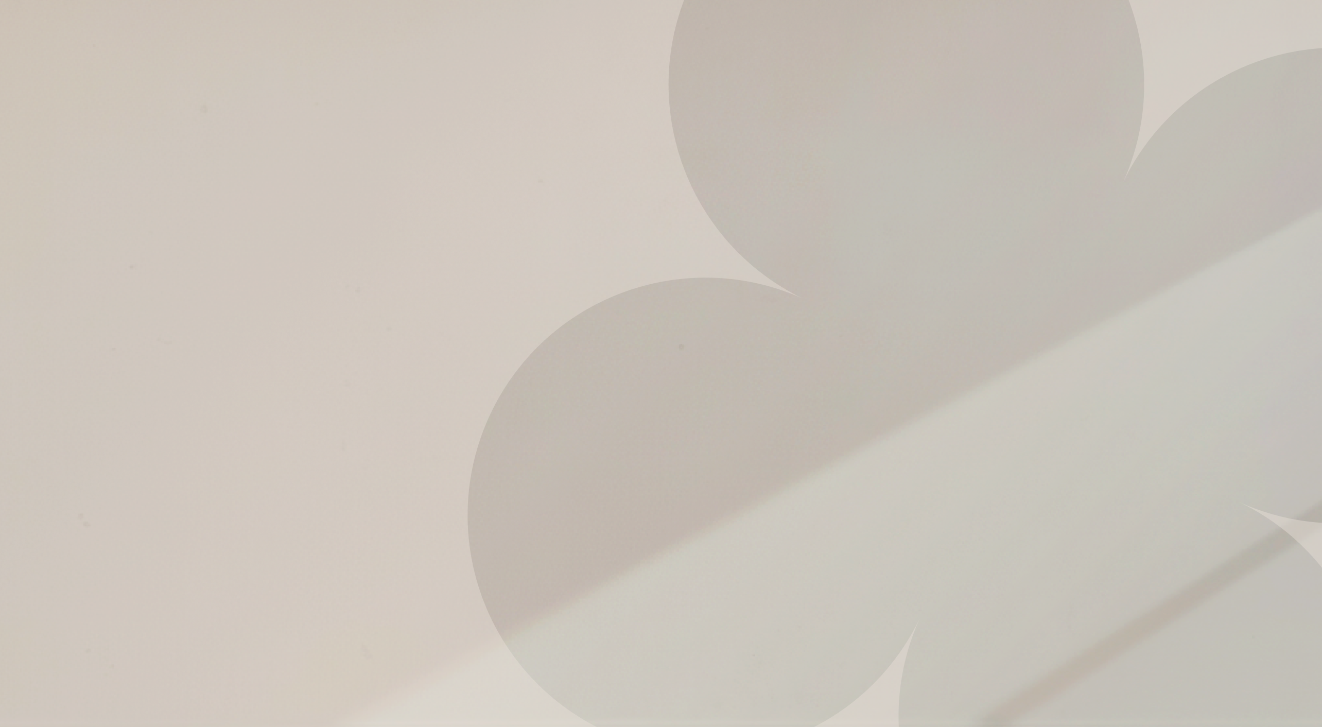 Close-up of a smooth, light-colored surface with soft shadows.