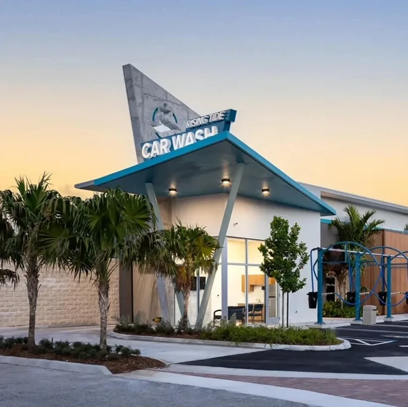 Newly built Rising Tide Car Wash Pompano Beach location at dusk, opening soon