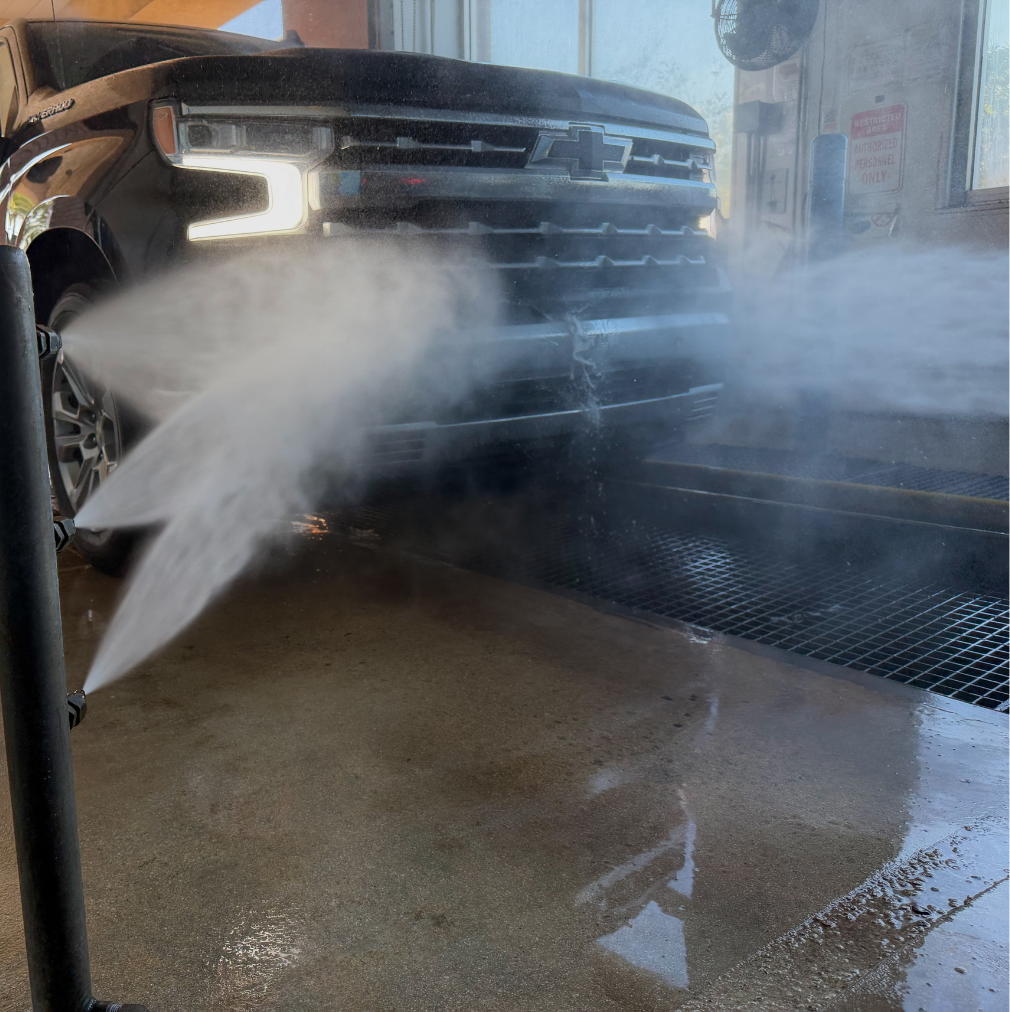 Pickup truck pre-rinse phase in the Rising Tide Coral Springs wash tunnel