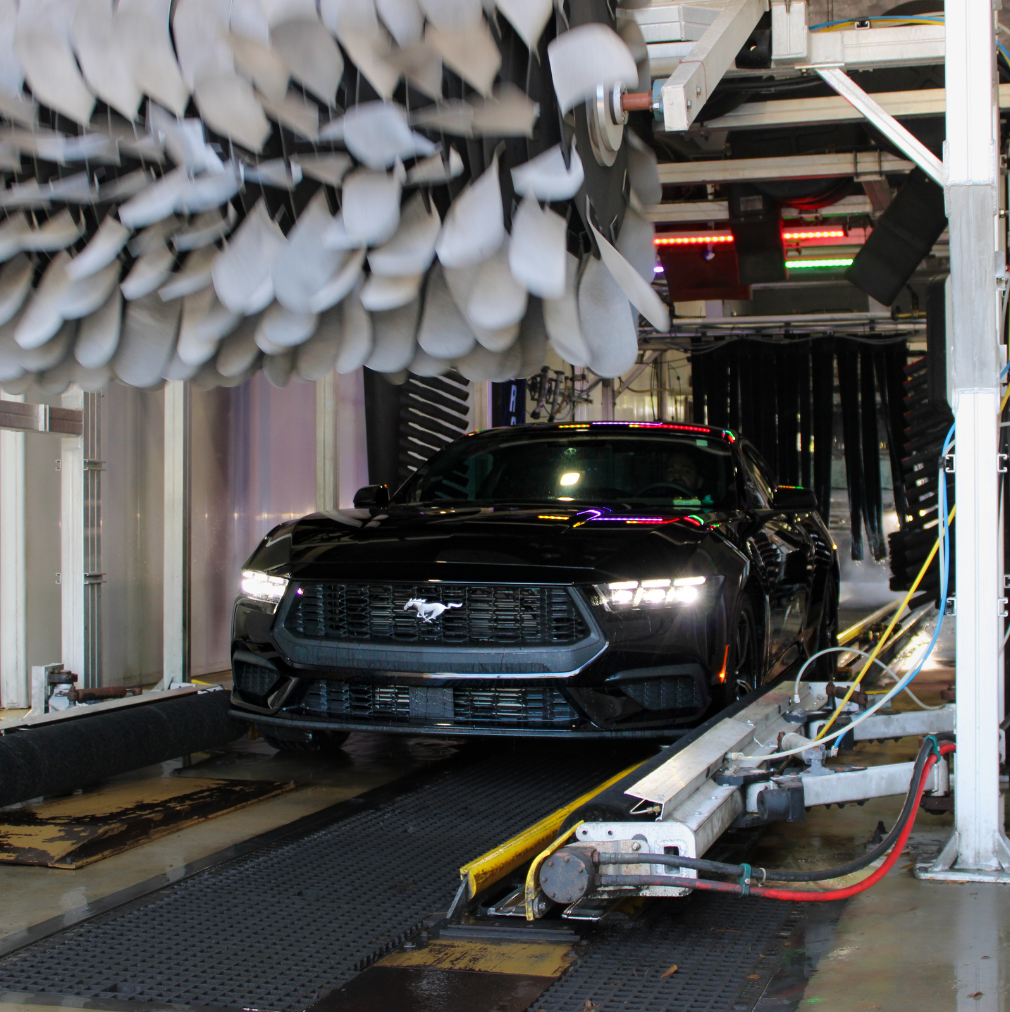 Black Ford Mustang under the foam mitter at Rising Tide Coral Springs
