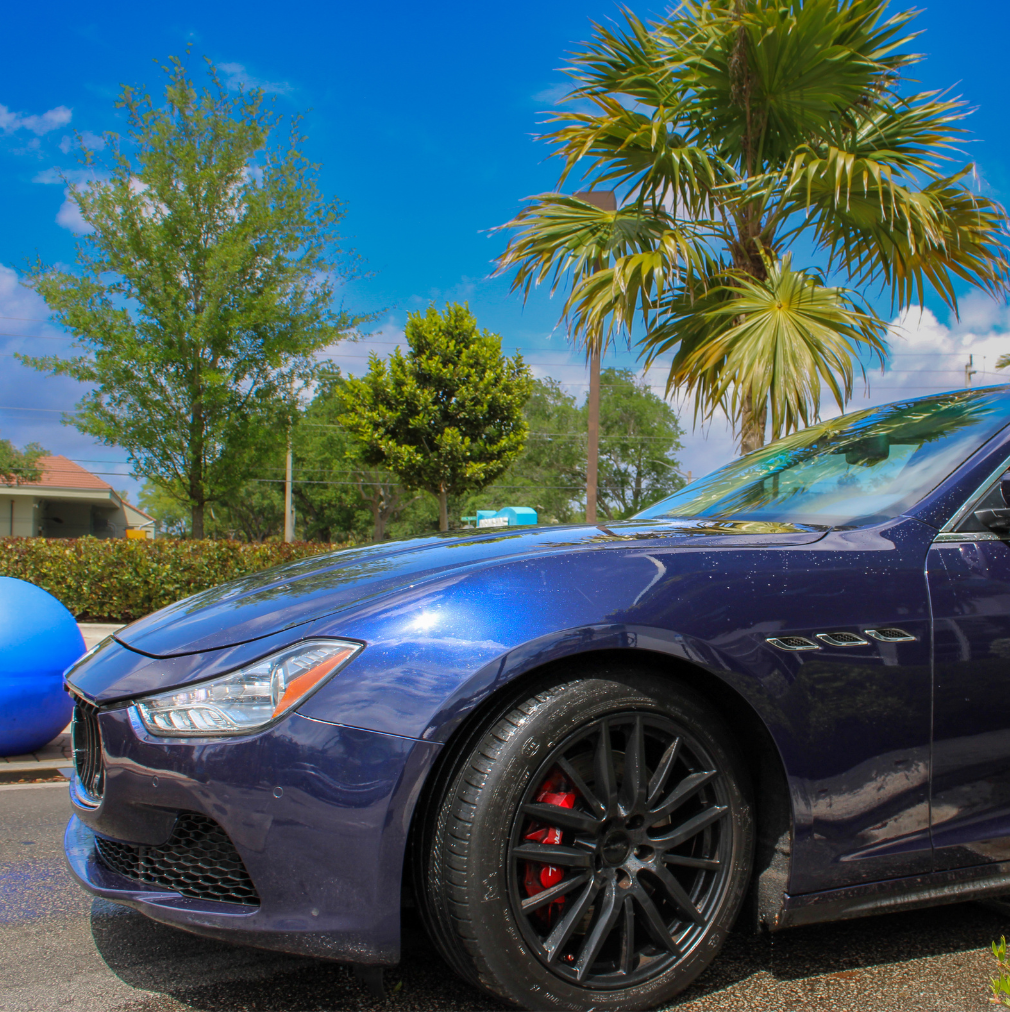 Blue Maserati Ghibli after exterior wash at Rising Tide Coral Springs