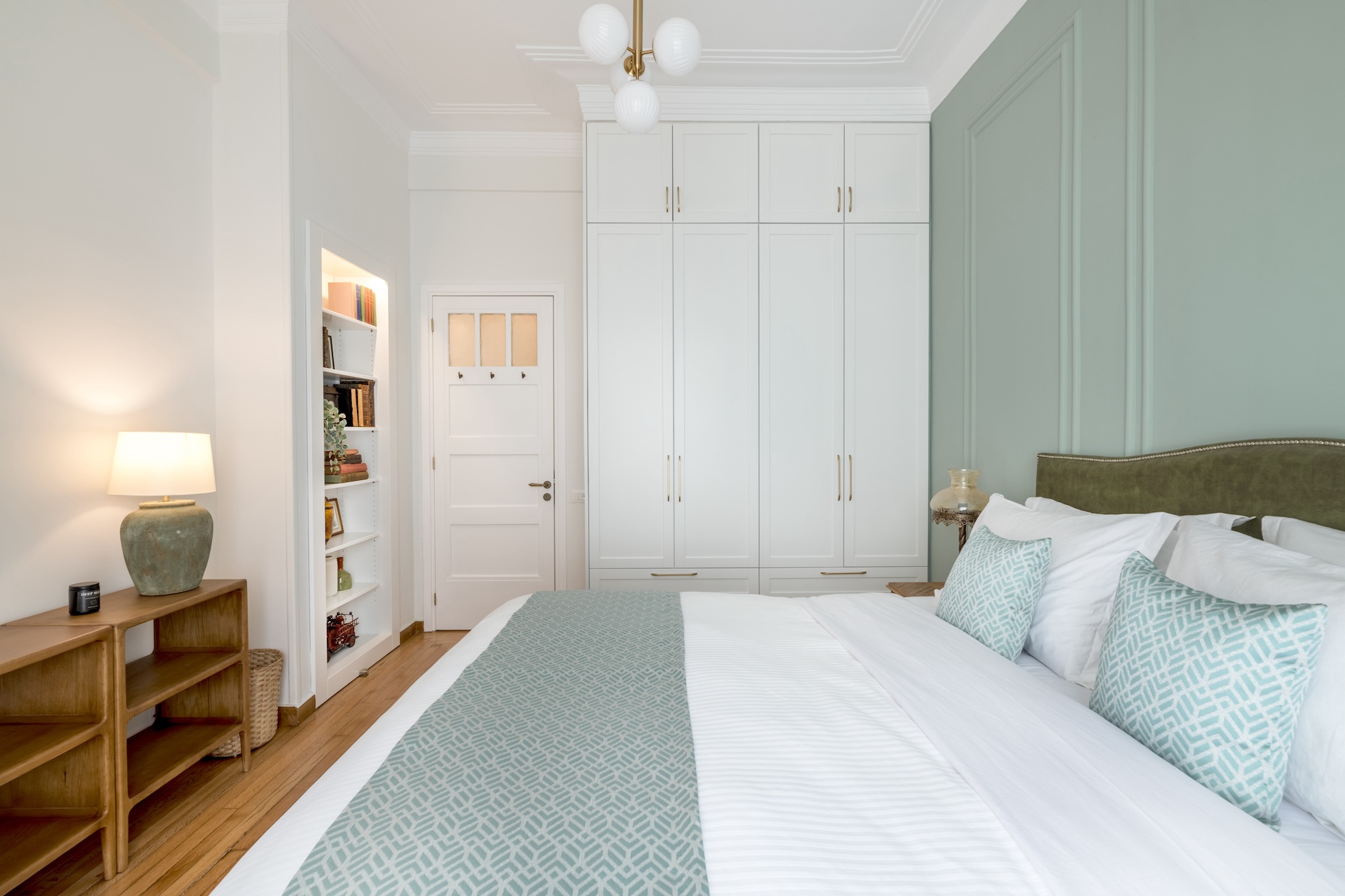 Bright bedroom with white bedding at The Hive apartment in Kypseli Athens