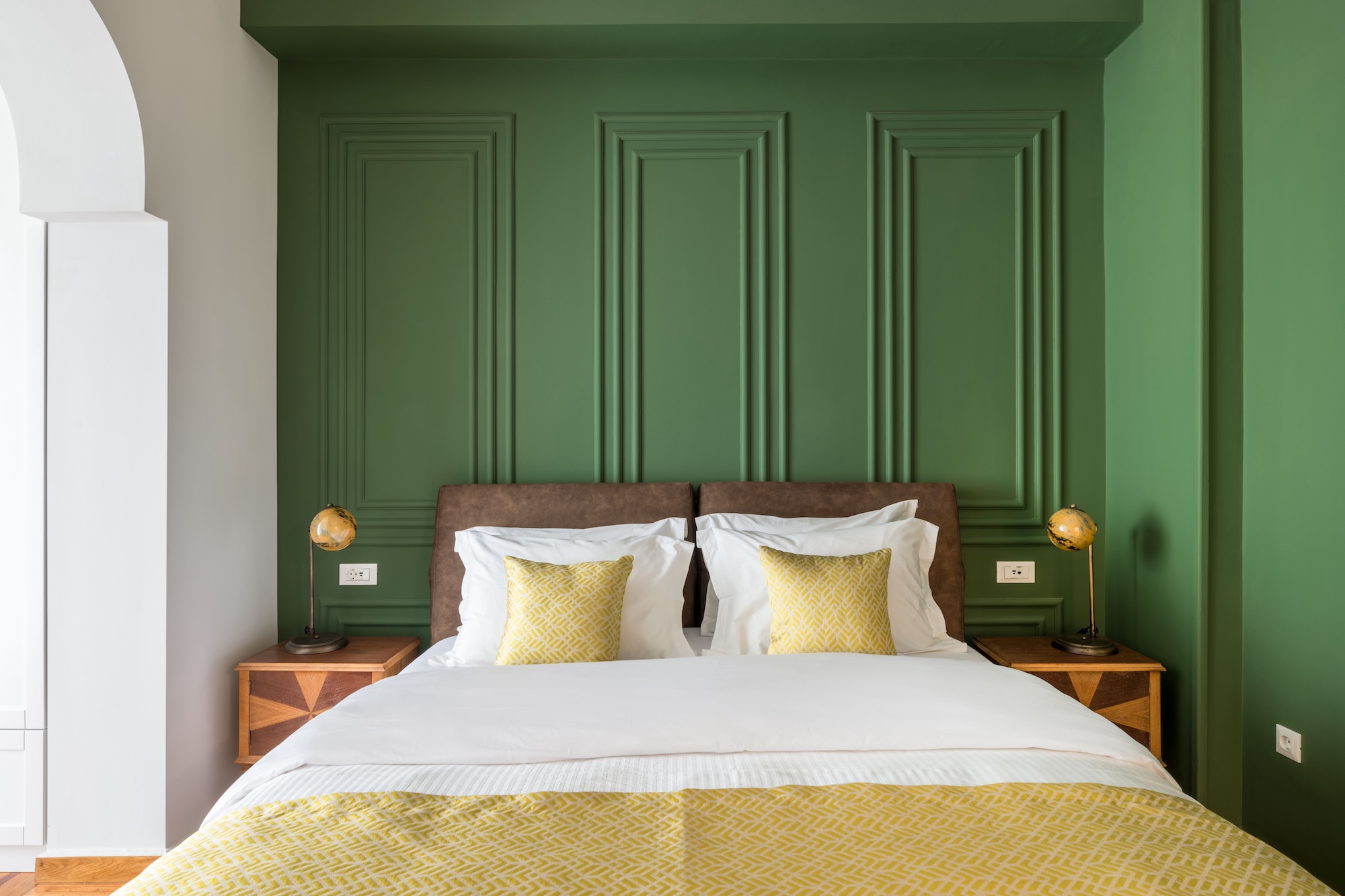 Green feature-wall bedroom at The Hive apartment in Kypseli Athens