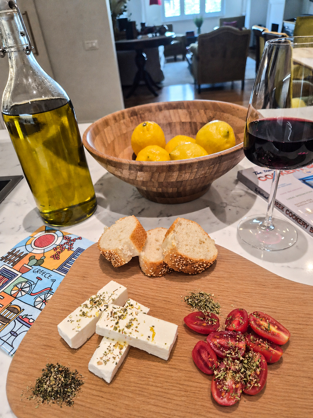 Greek meze ingredients with feta, tomatoes, bread, olive oil and red wine prepared at The Hive in Athens
