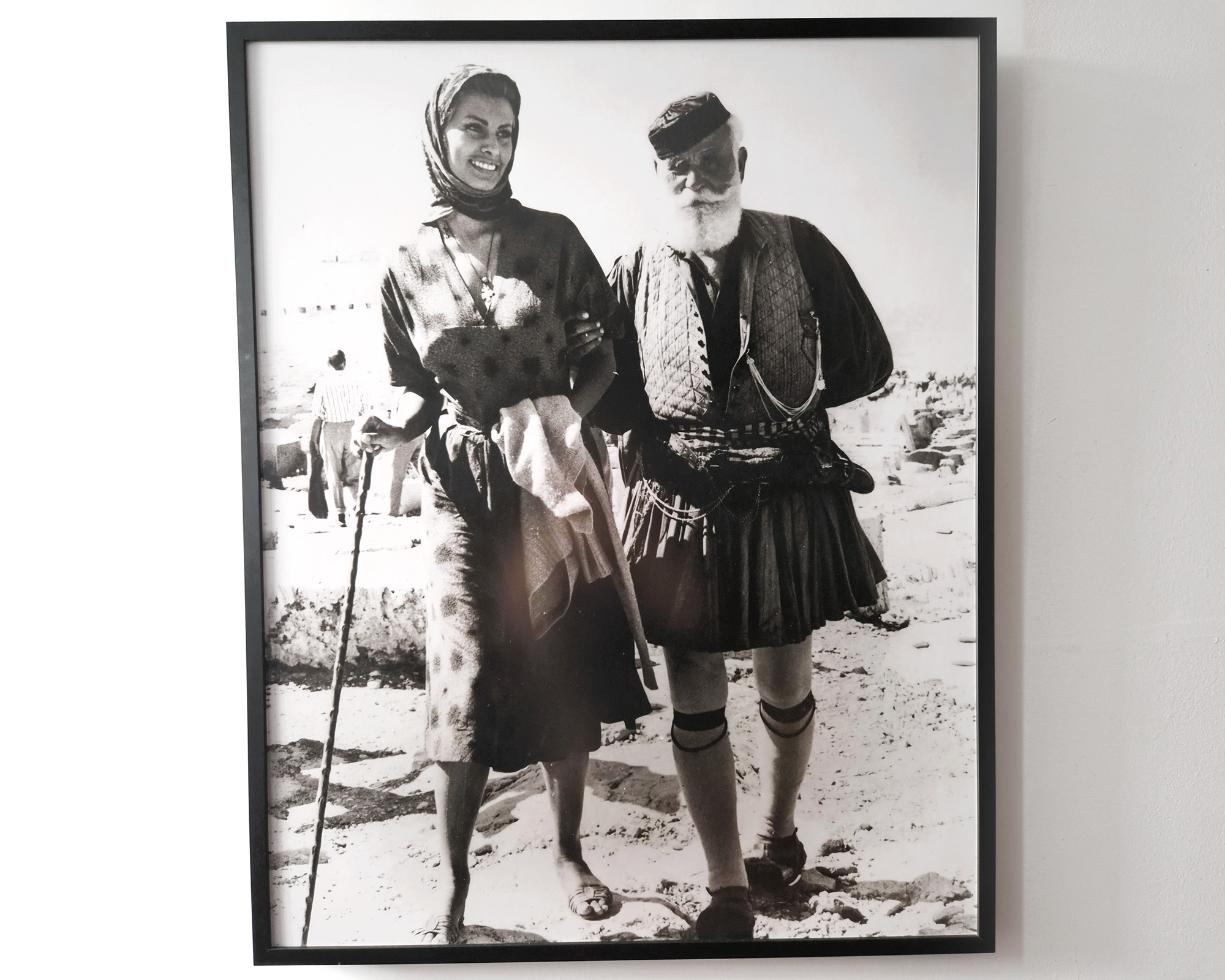 Framed black-and-white photograph of Sophia Loren and a man in traditional Greek clothing at Silk House.