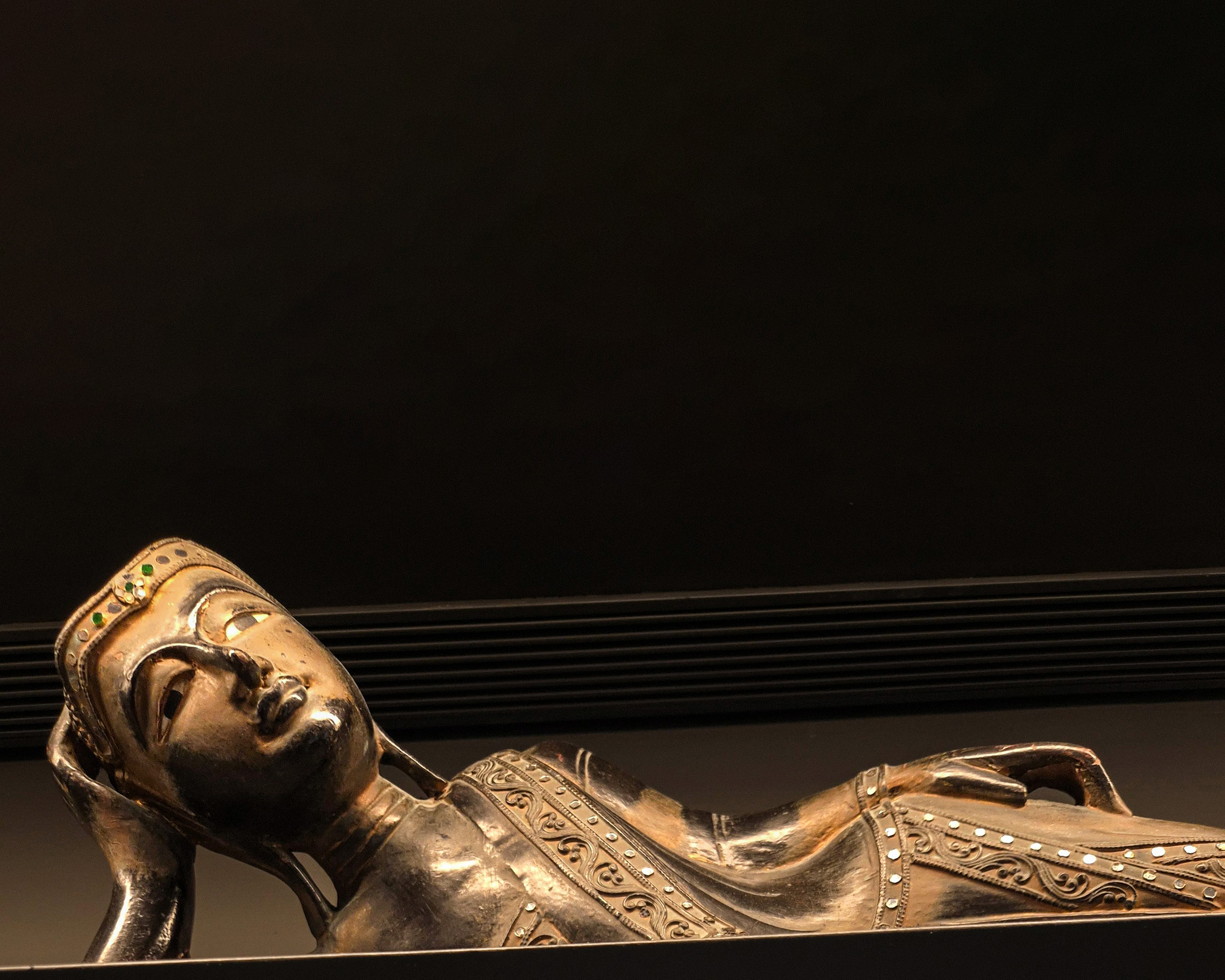 Bronze-toned reclining sculpture in the art-filled interior of Silk House in Metaxourgeio.