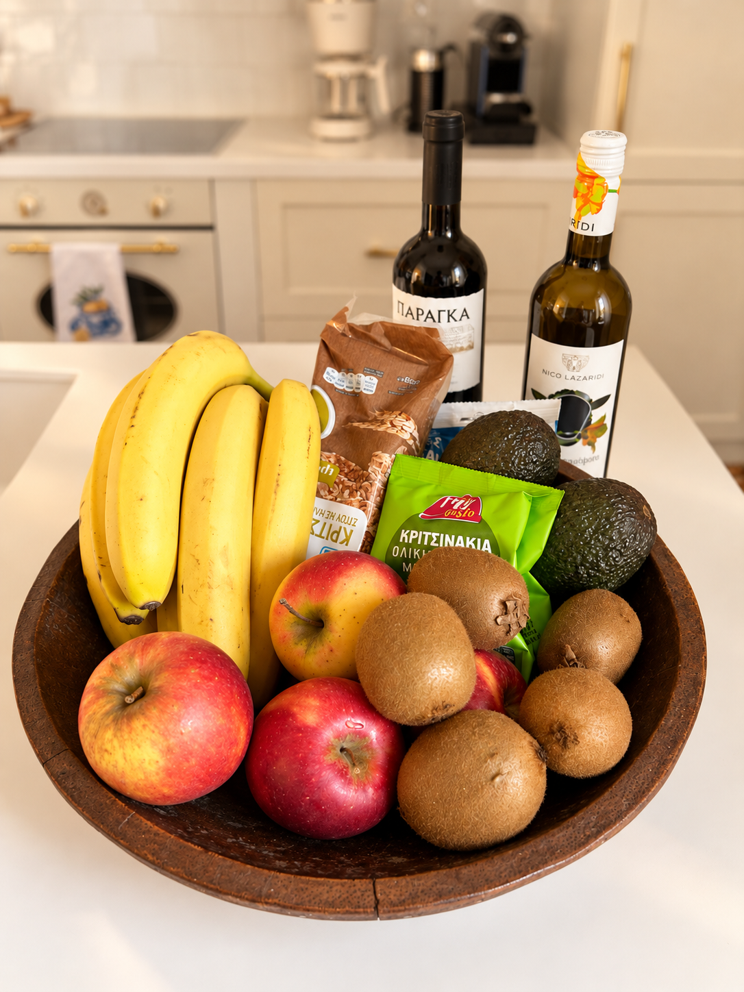 Welcome basket with fresh fruit, snacks and wine in a Halo Collection Athens home
