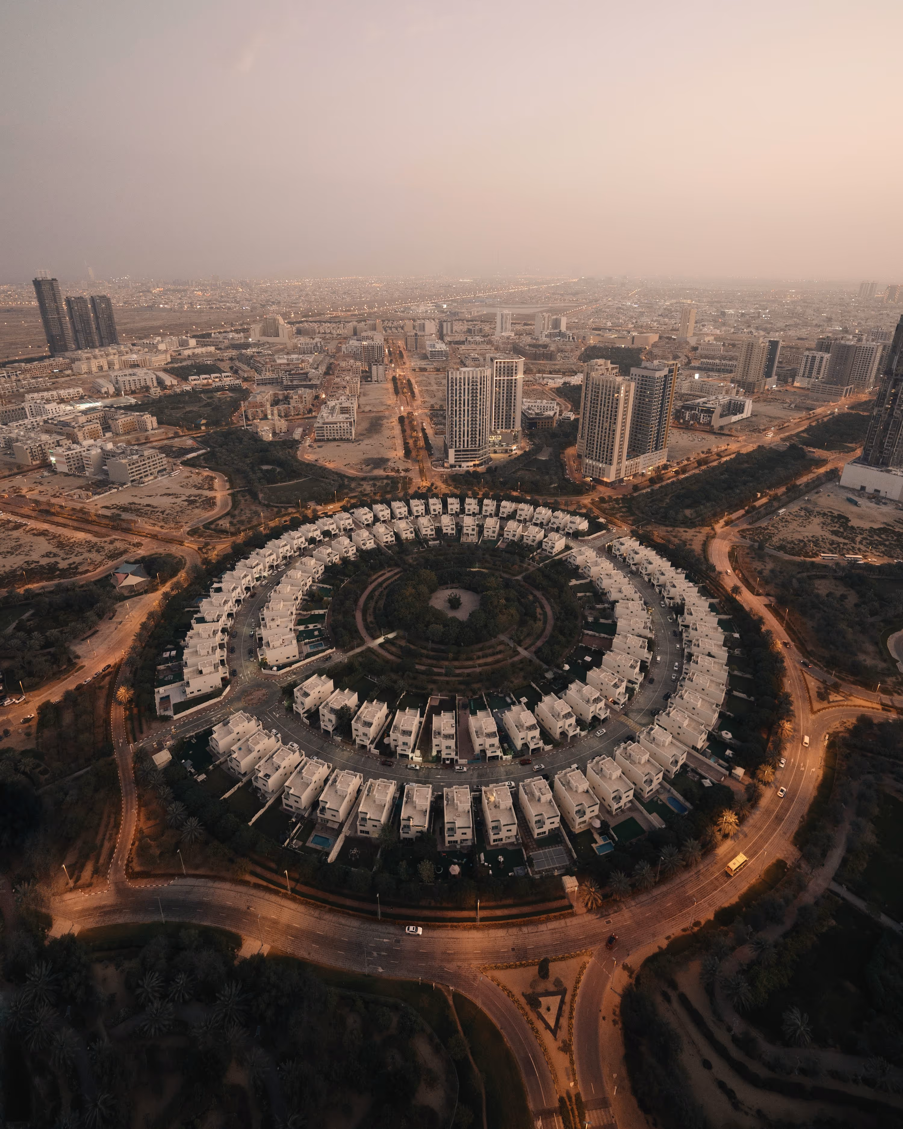 an aerial view of a city with a circular building