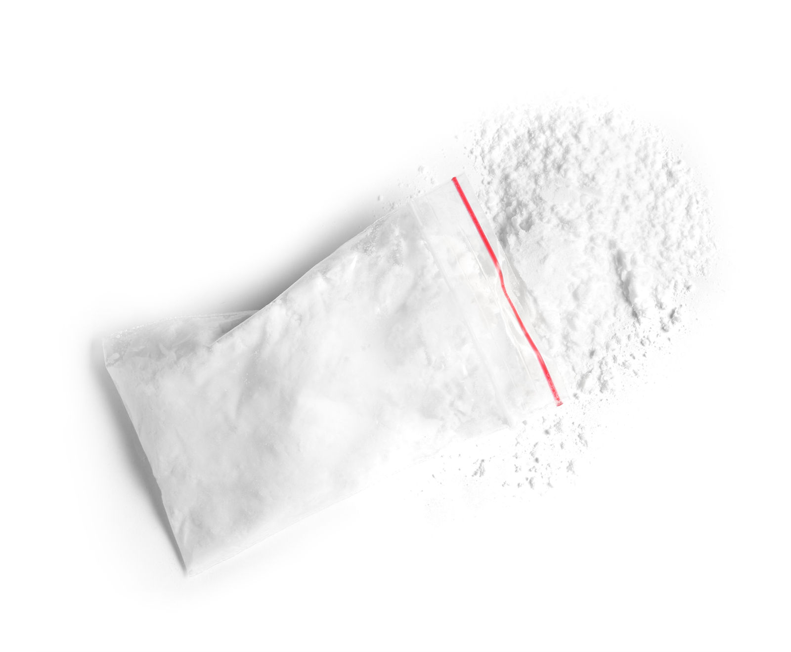 Sealed clear bag and white powder on a white surface, representing cocaine and recreational drug use