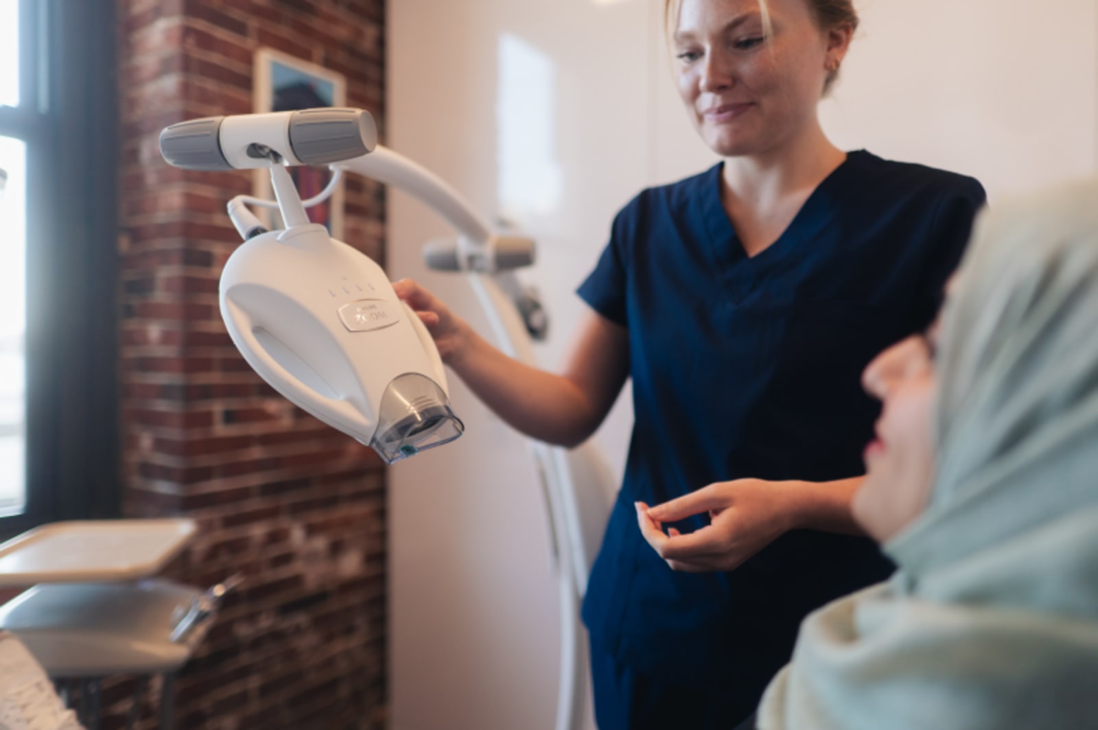 Dentist showing dental model to patient during evaluation appointment