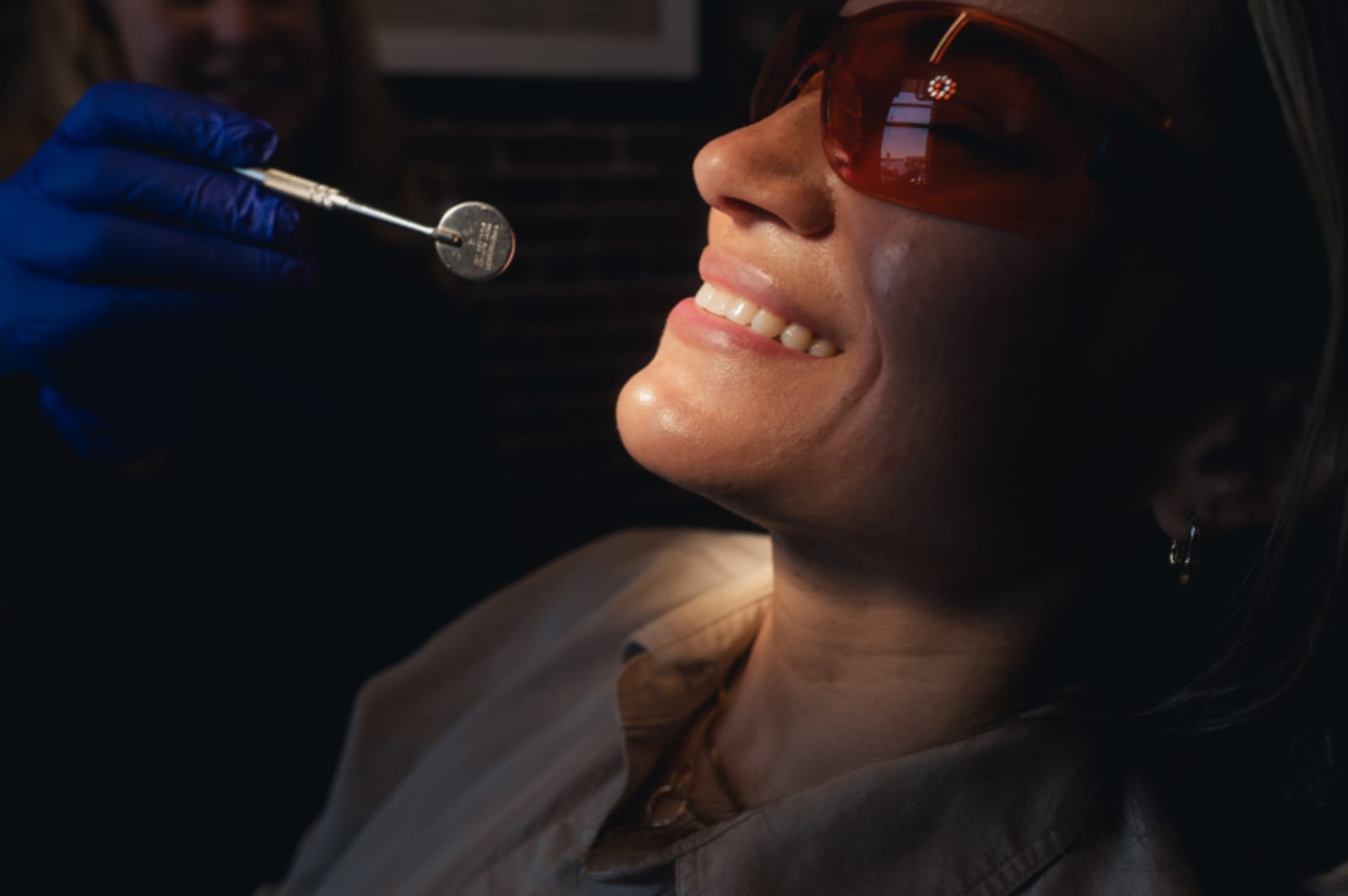 Dentist performing dental examination with instrument on patient