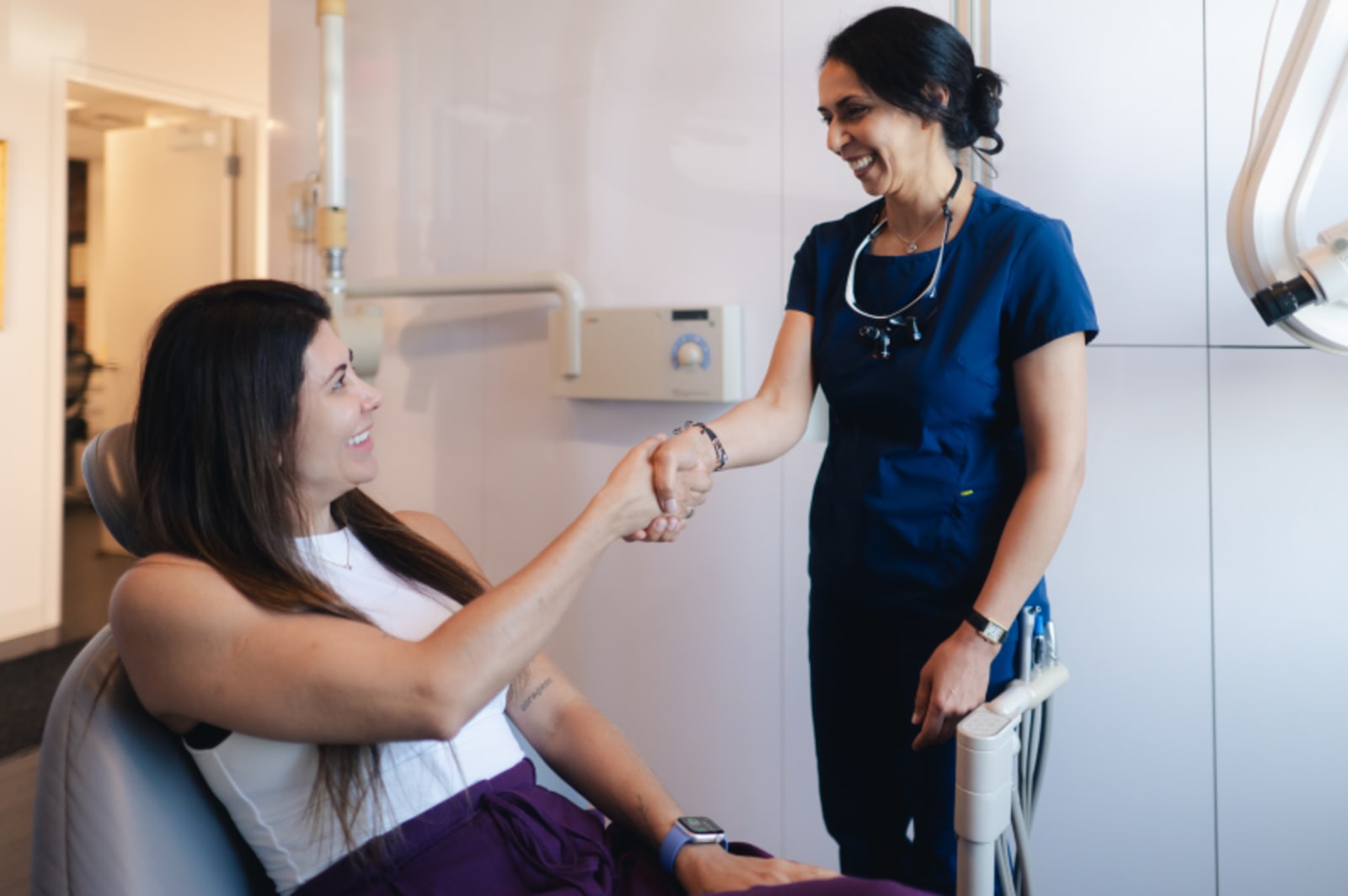 Dentist discussing treatment plan with patient in operatory