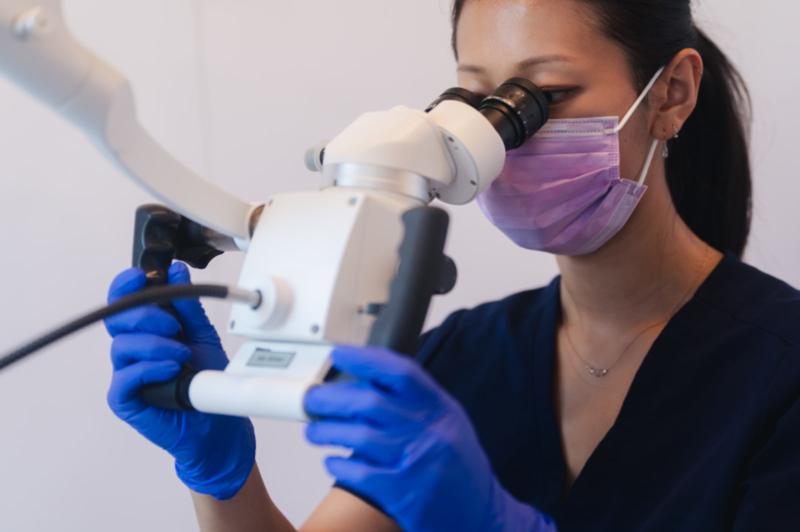 Dental professional holding an intraoral scanner during patient examination