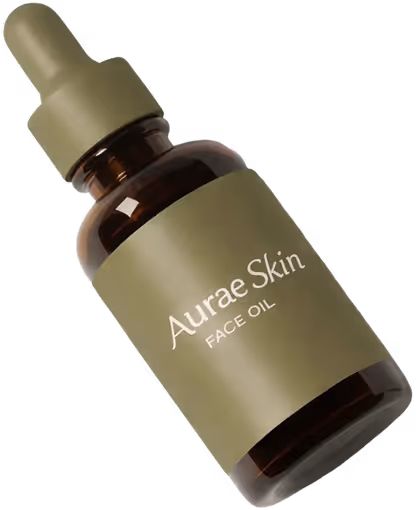 Brown glass dropper bottle labeled 'Aurae Skin FACE OIL' with greenish-beige cap and label.