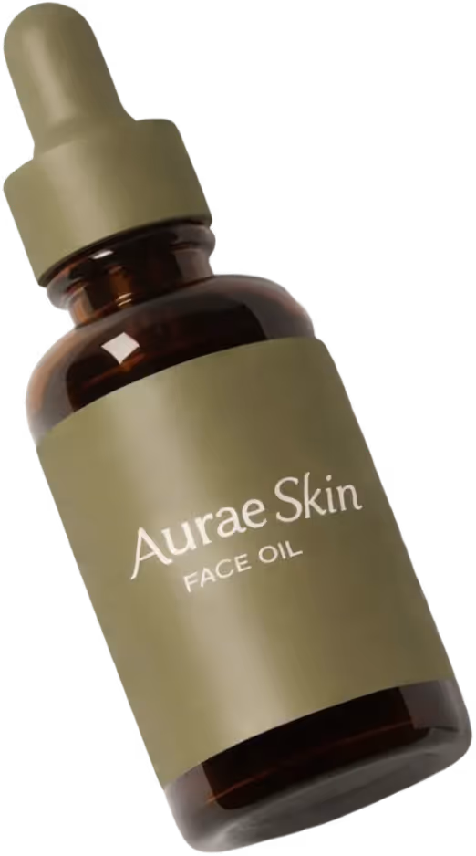 Brown glass bottle with olive green dropper cap and label reading Aurae Skin Face Oil.