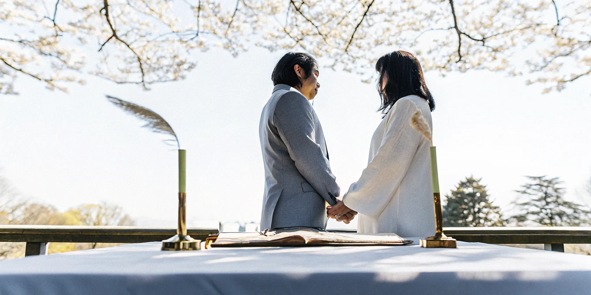 An officiant's unique wedding ceremony script sits on a table during an outdoor wedding.