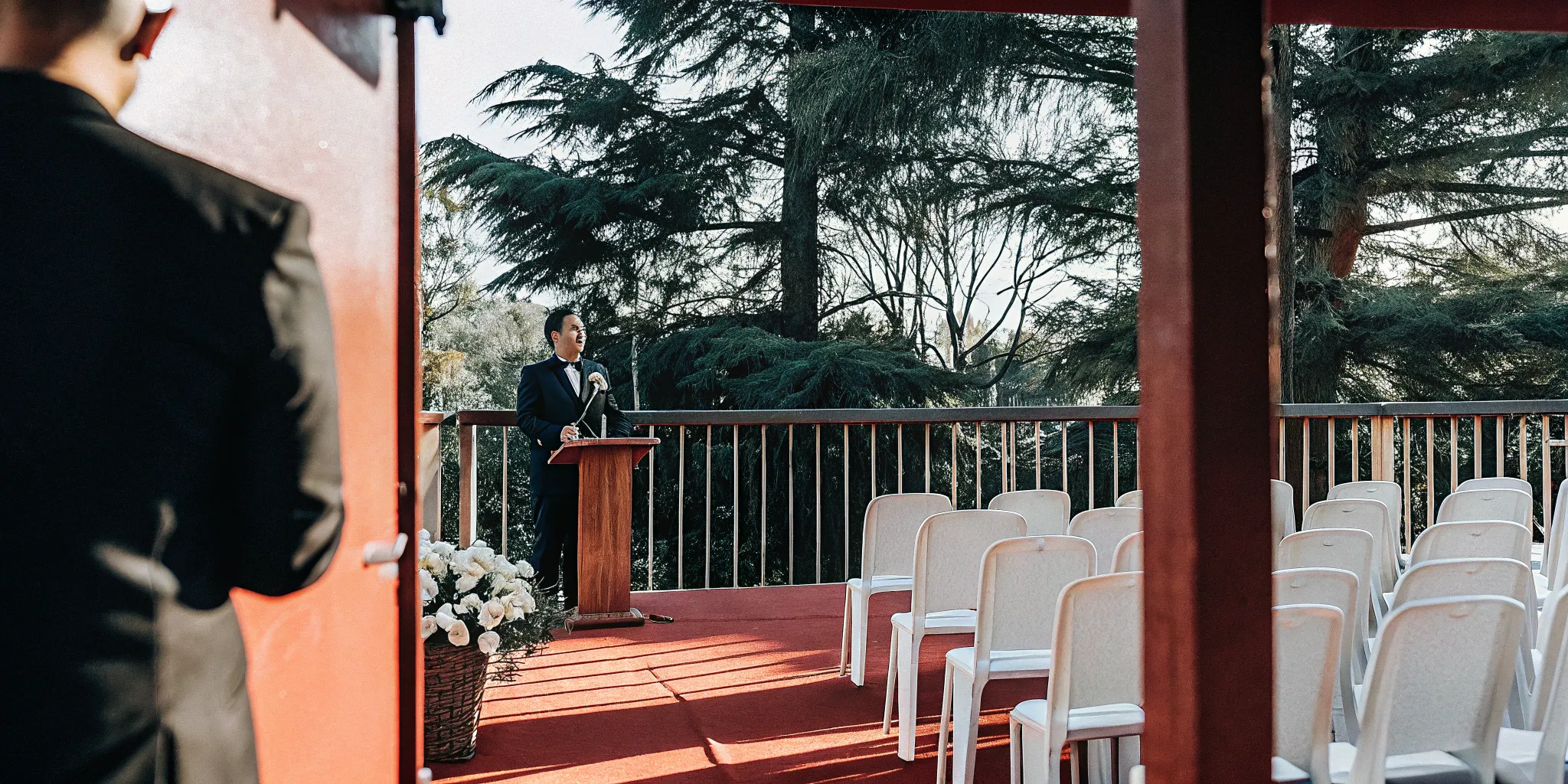 A wedding officiant at an outdoor ceremony, a visual representing marketing for wedding officiants.