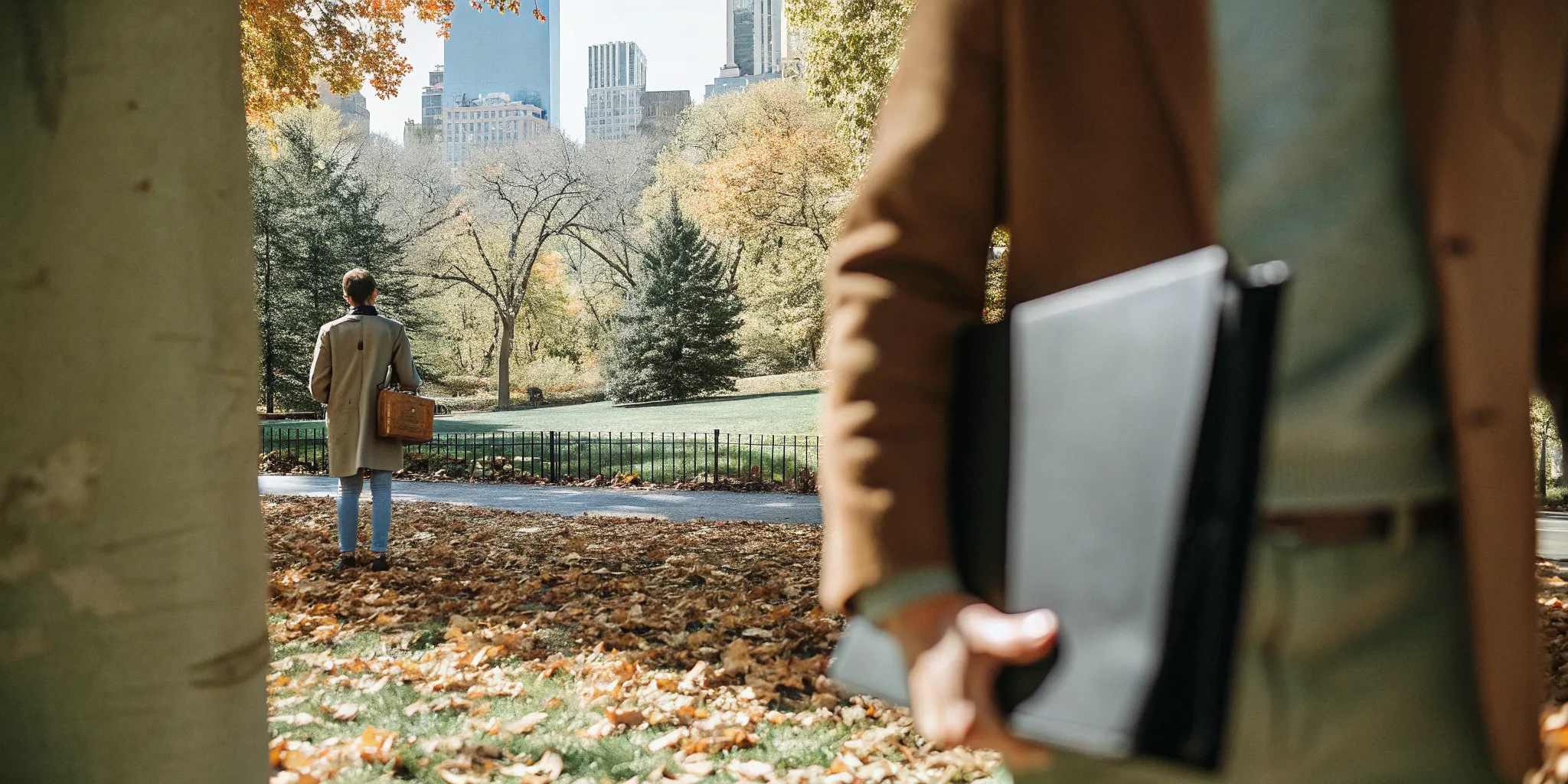 A New York wedding officiant reviewing legal requirements with a client in a city park.