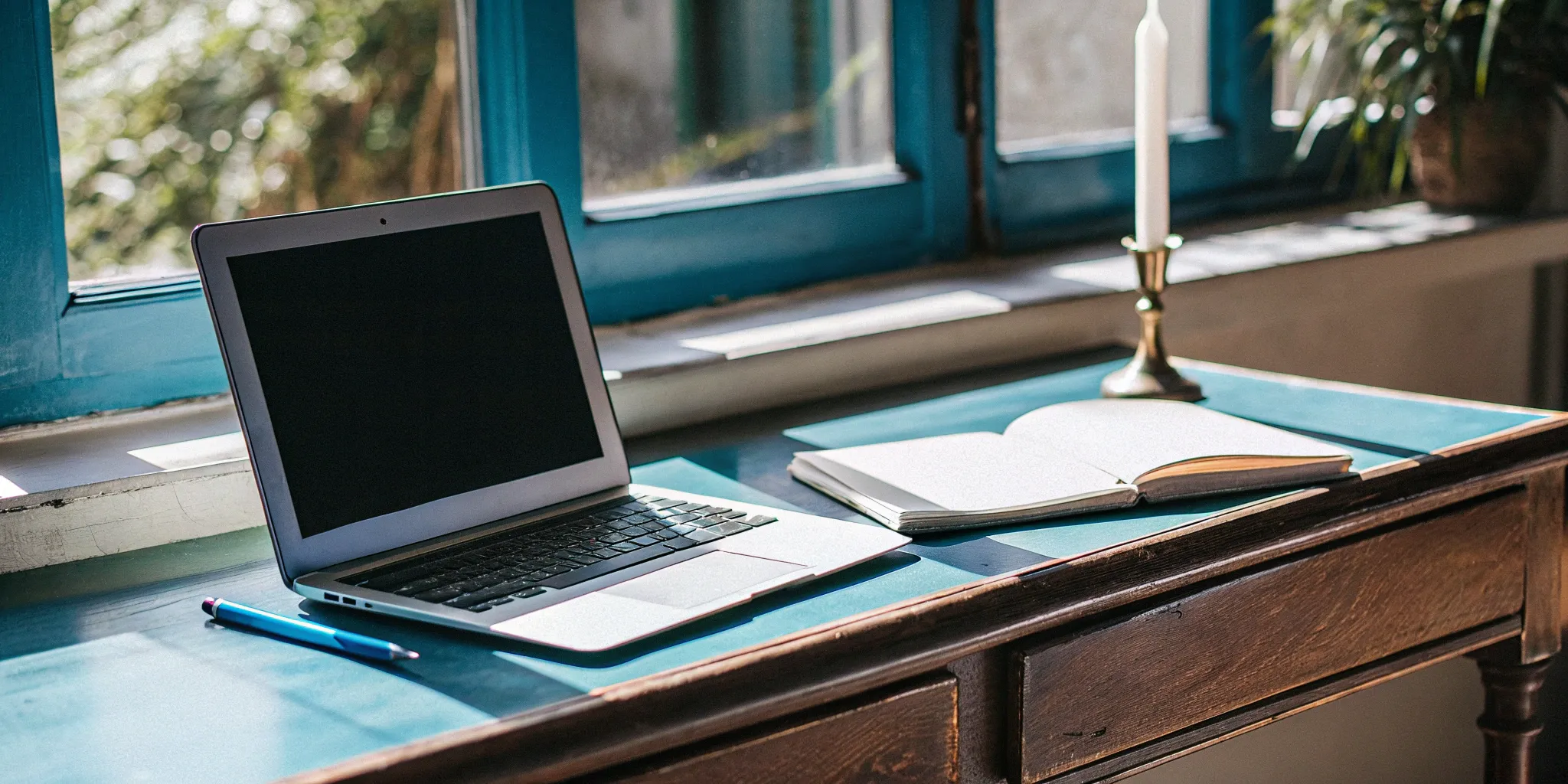 Online ministry ordination tools: Laptop, notebook, and pen.