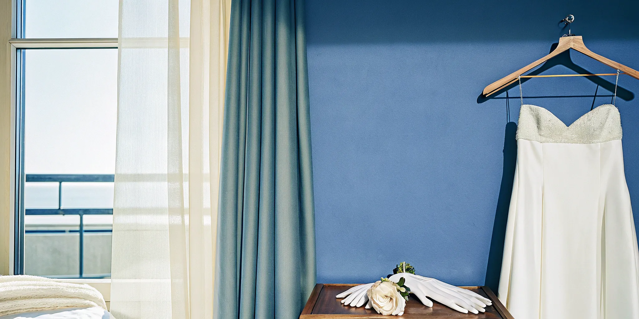 A white wedding dress on a hanger, a key consideration for the wedding officiant dress code.