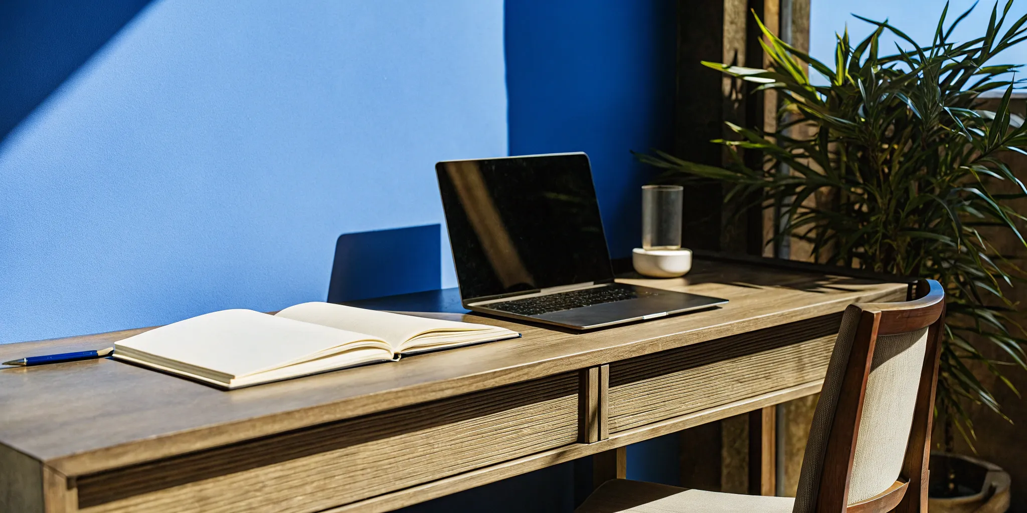 Desk with a laptop and notebook for researching Virginia marriage officiant requirements.