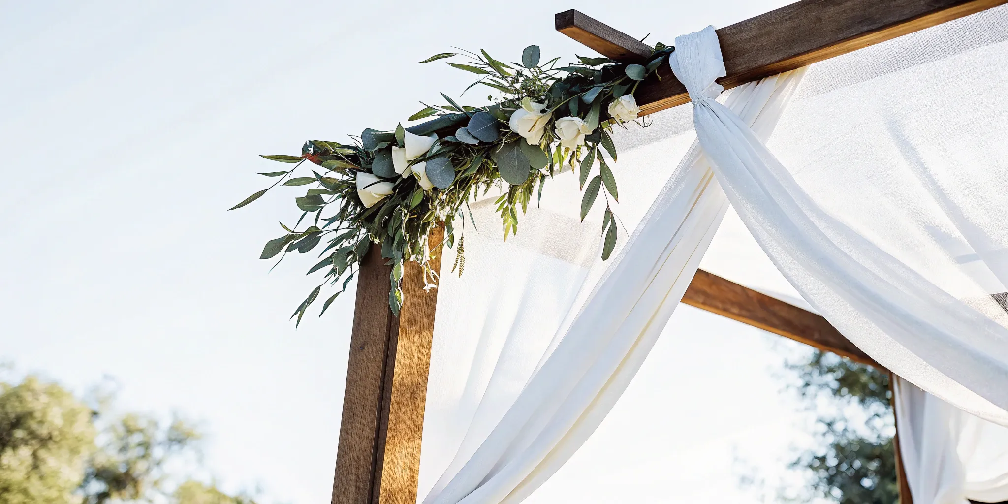 Wooden wedding arch with drapery for a traditional wedding ceremony script.