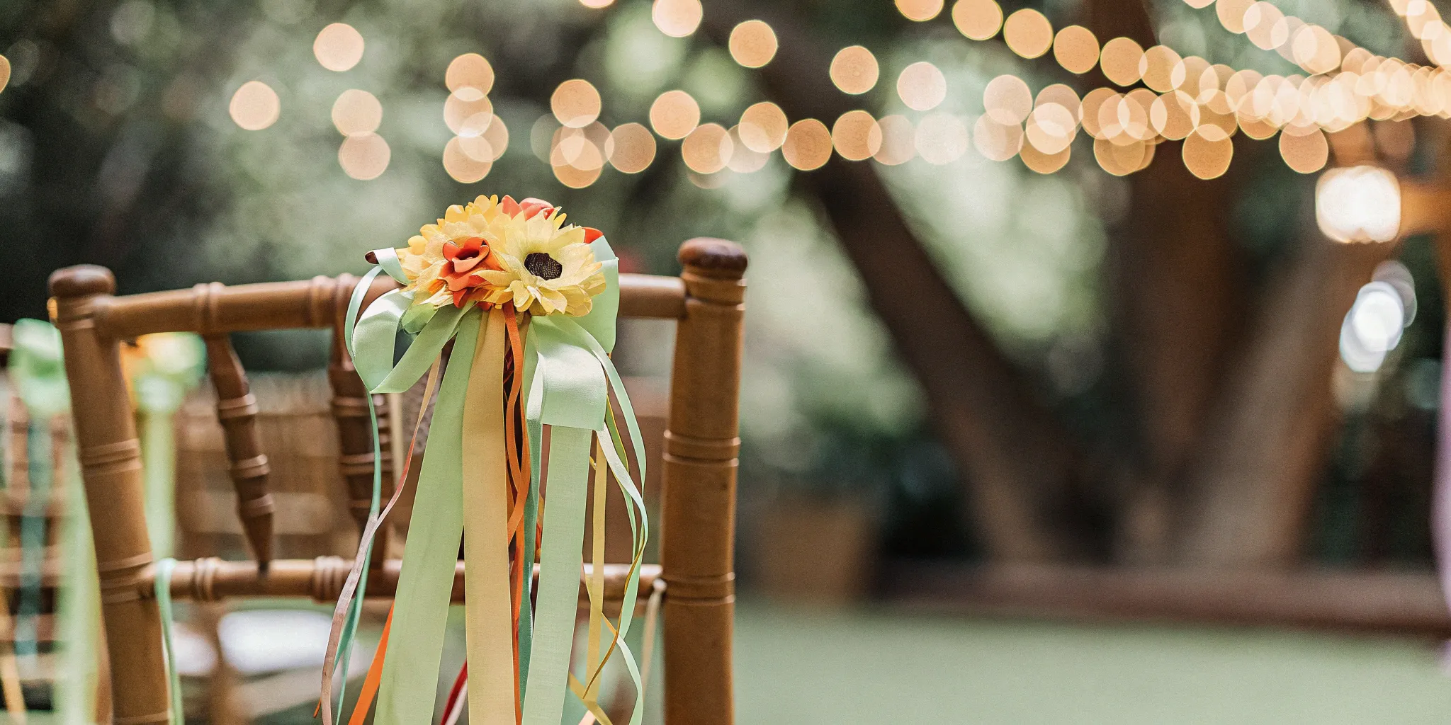 A chair with sunflowers and ribbons prepared for a funny wedding ceremony.