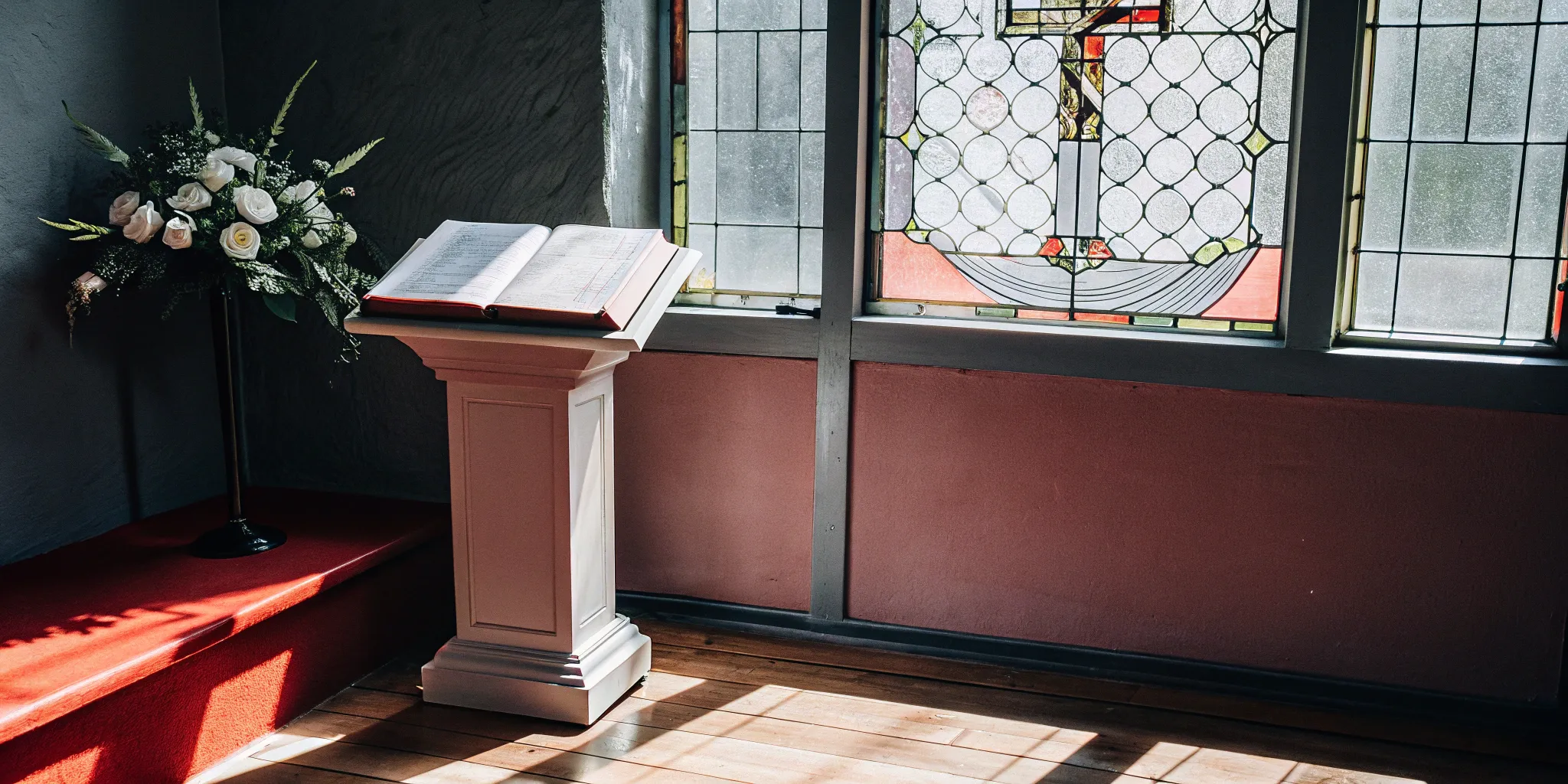 An open Bible on a lectern with a script for an ordination ceremony.