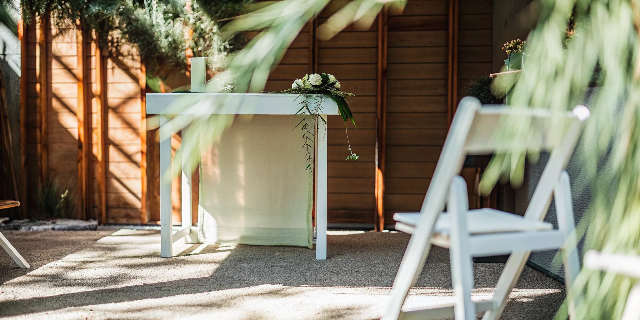 Minimalist wedding ceremony with white chairs, ready for a short, personalized script.