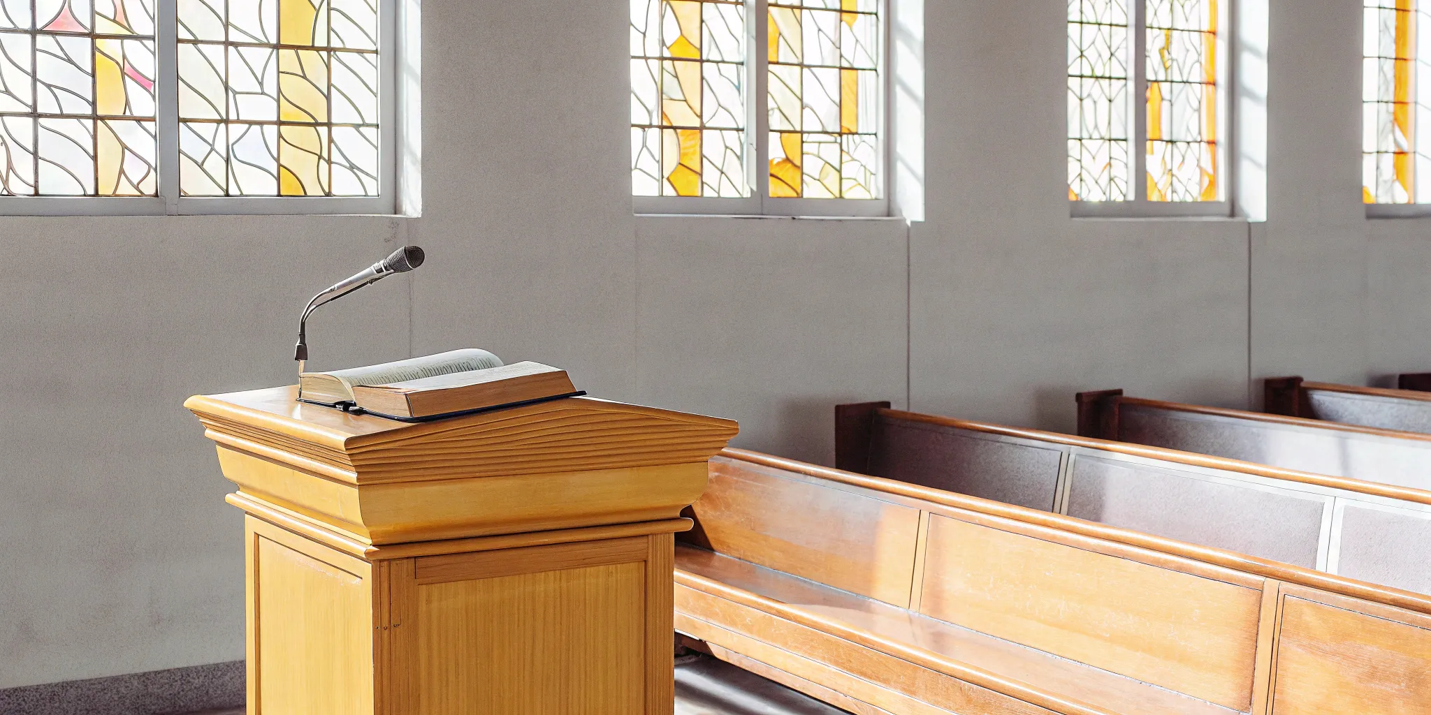 A church pulpit with an open book, where a religious officiant leads the ceremony.
