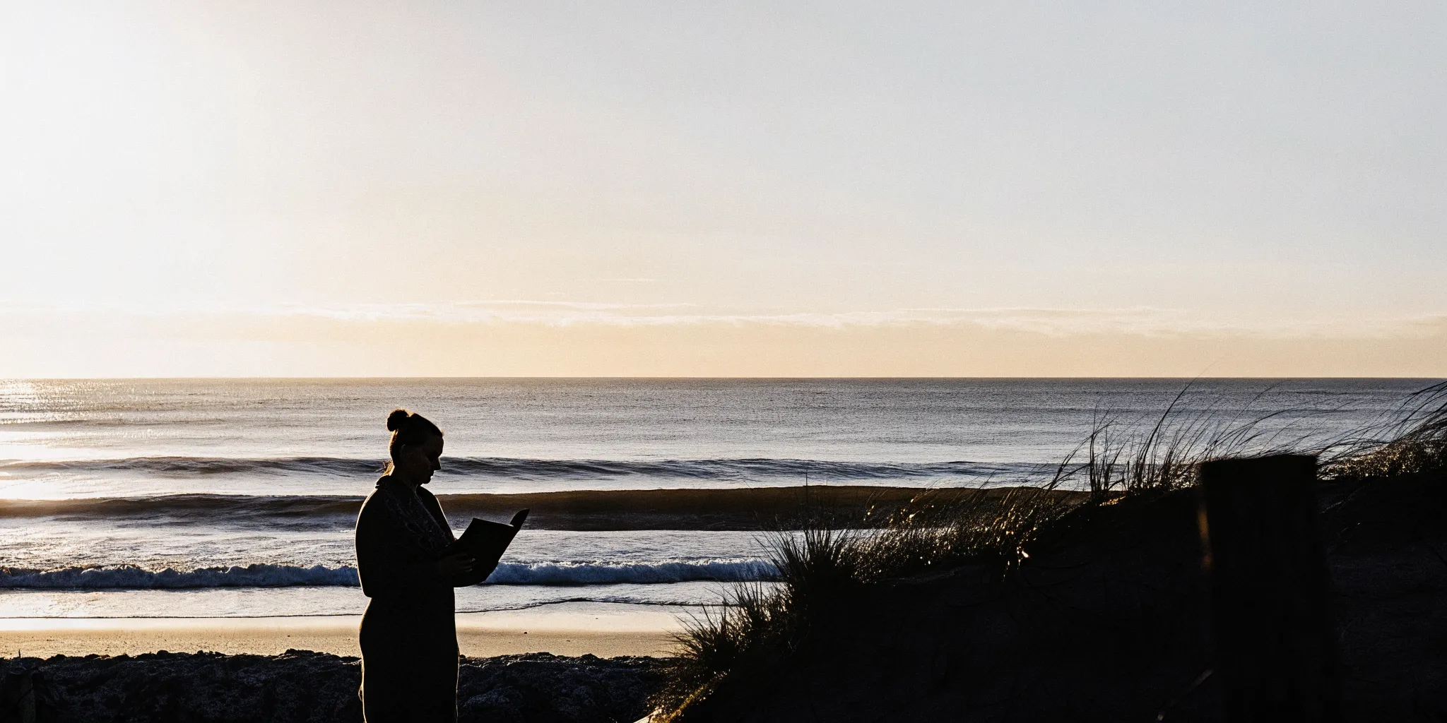 A person becomes an ordained minister online using a laptop on a Florida beach.