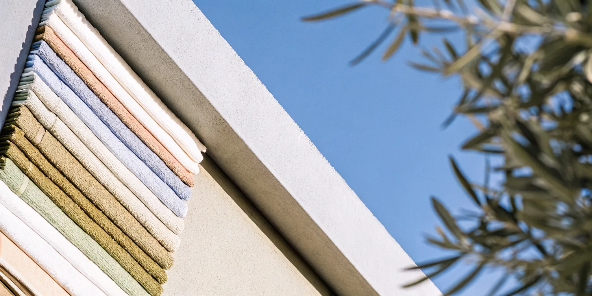 Colorful folded towels stacked neatly, a simple idea for unique side gigs with low startup costs.